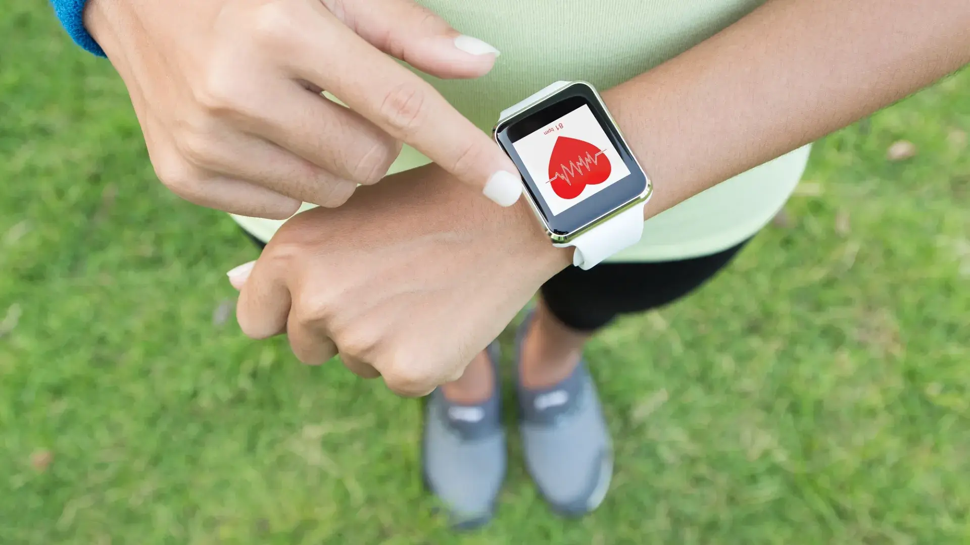 photo of a wrist with a smartwatch displaying heartrate