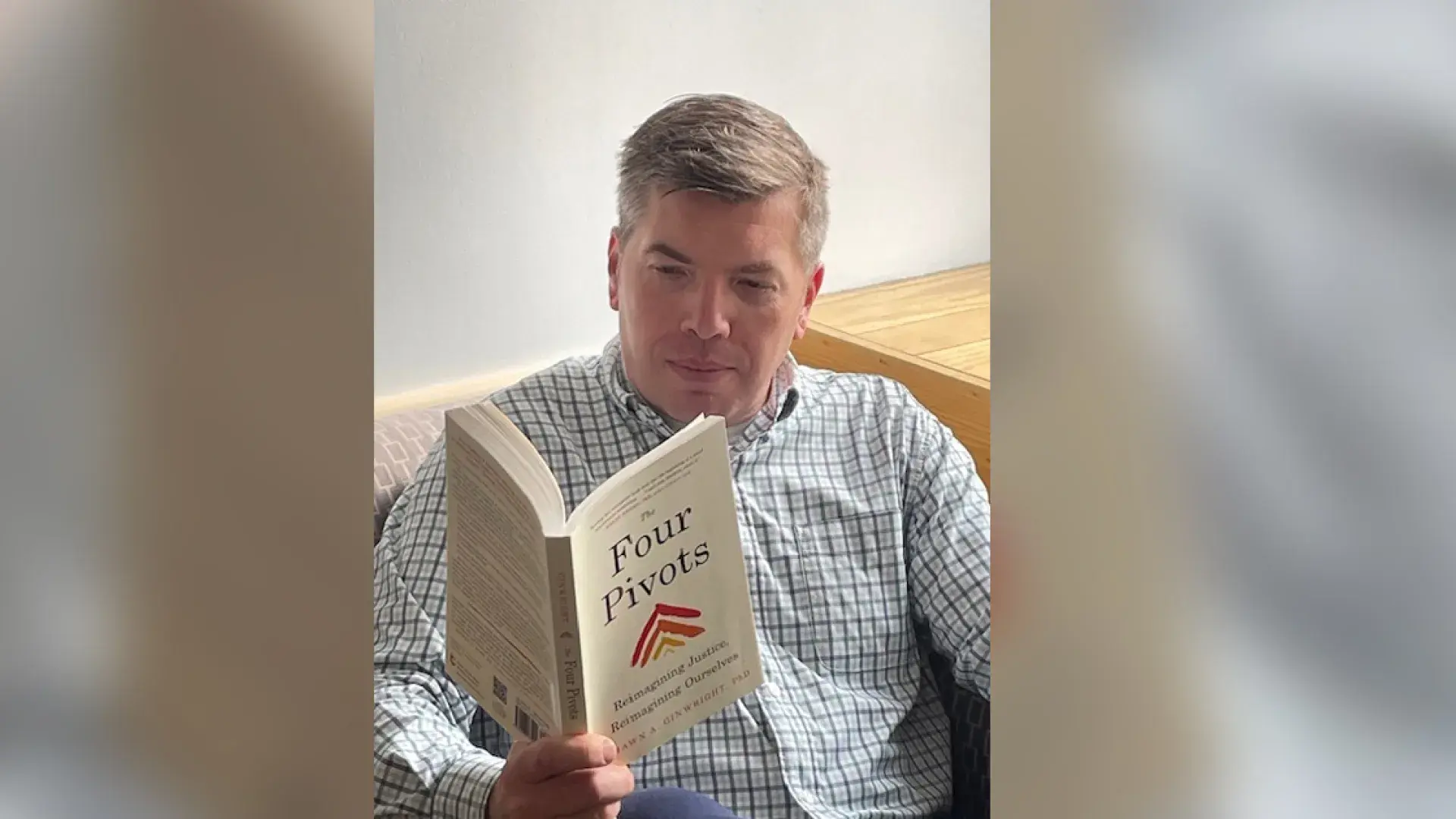 A man reads the book Four Pivots