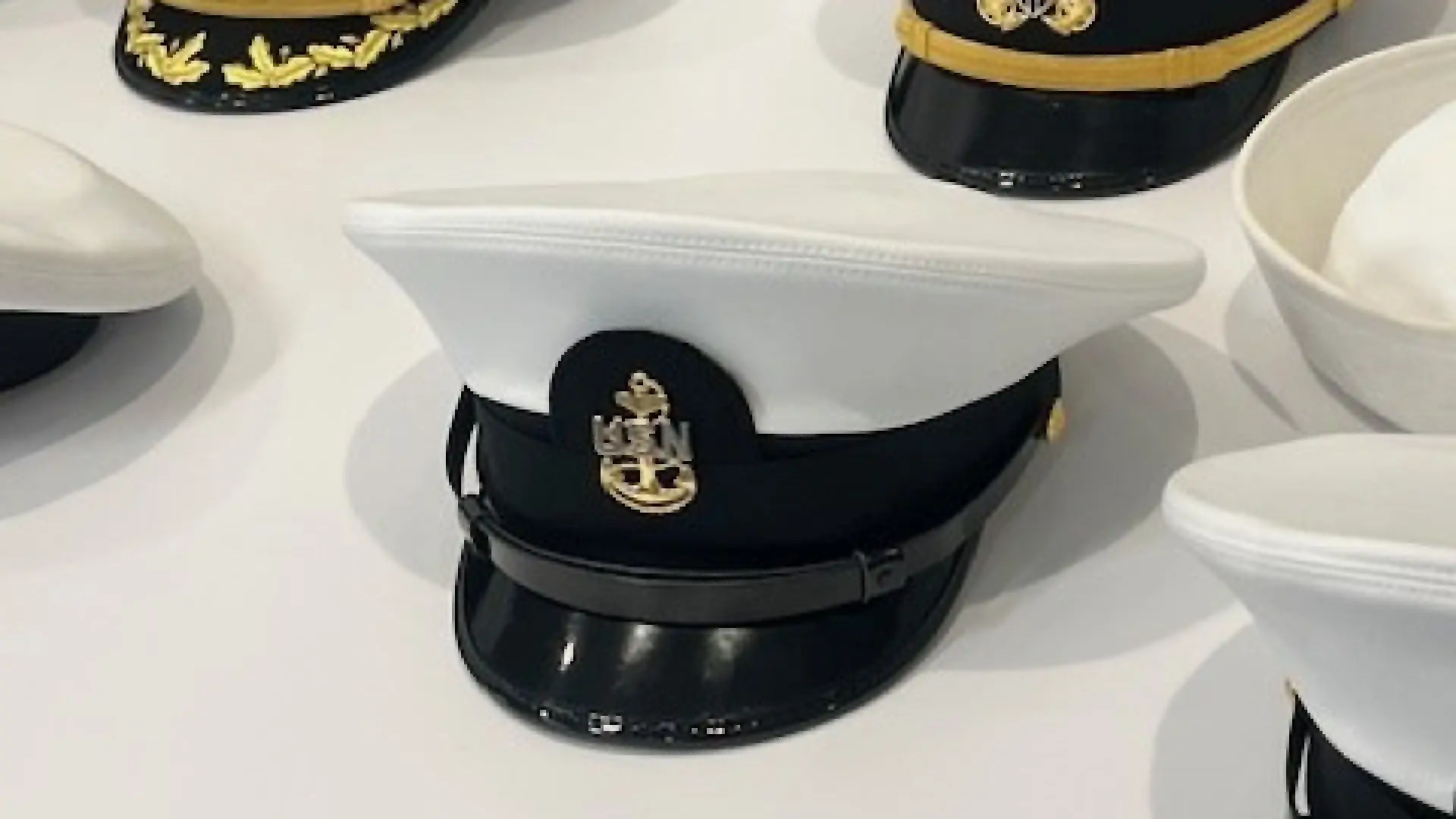 Several hats from a Navy uniform