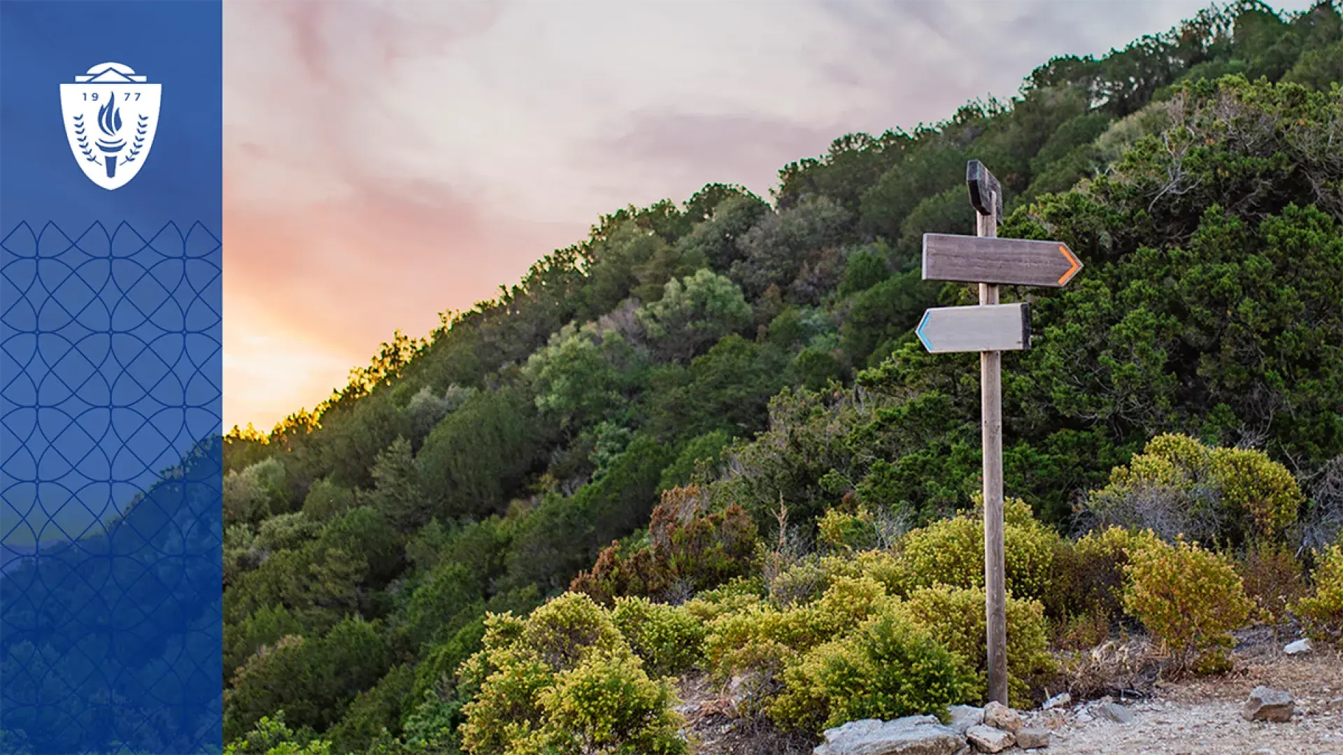 a sign post on a path in the mountains