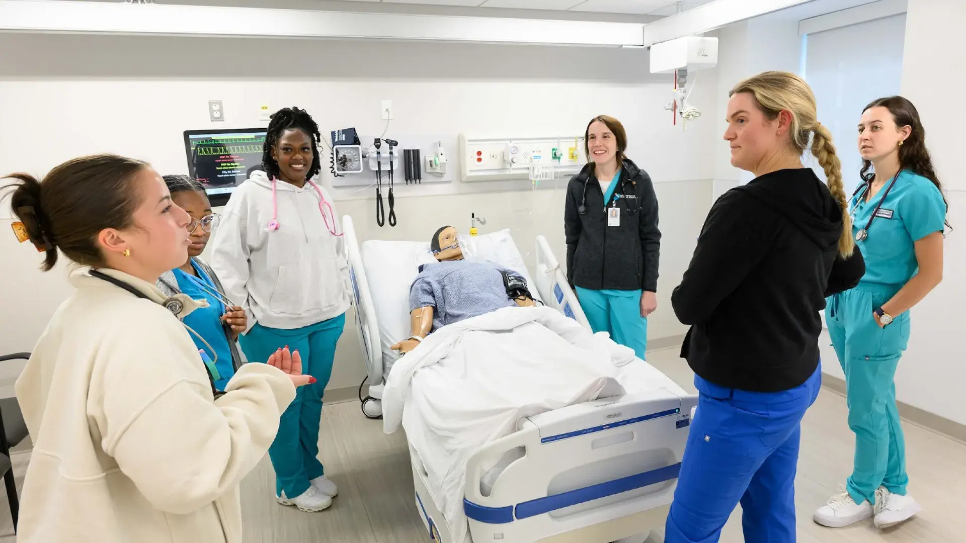 nursing students debrief after a simulation, part of their intensive nursing training