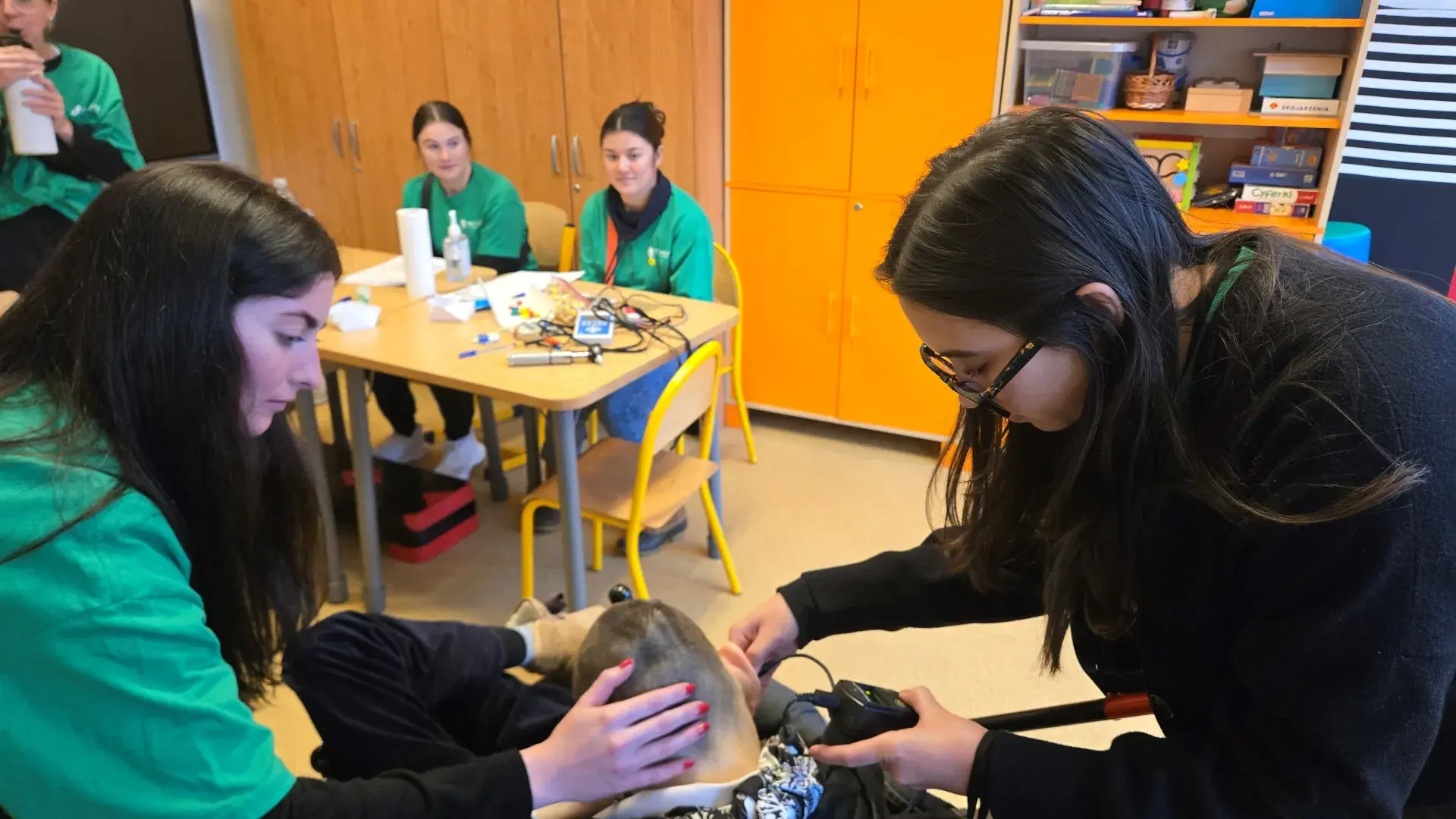 two students with child patient 