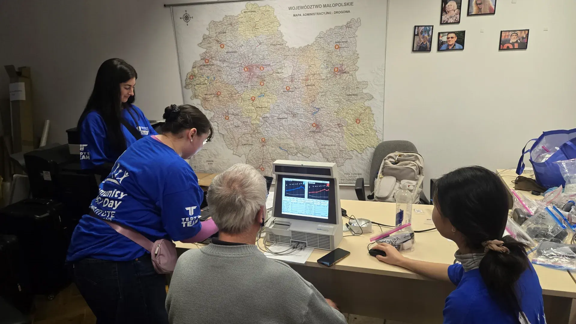 Three students using ear measurements to fit patient 