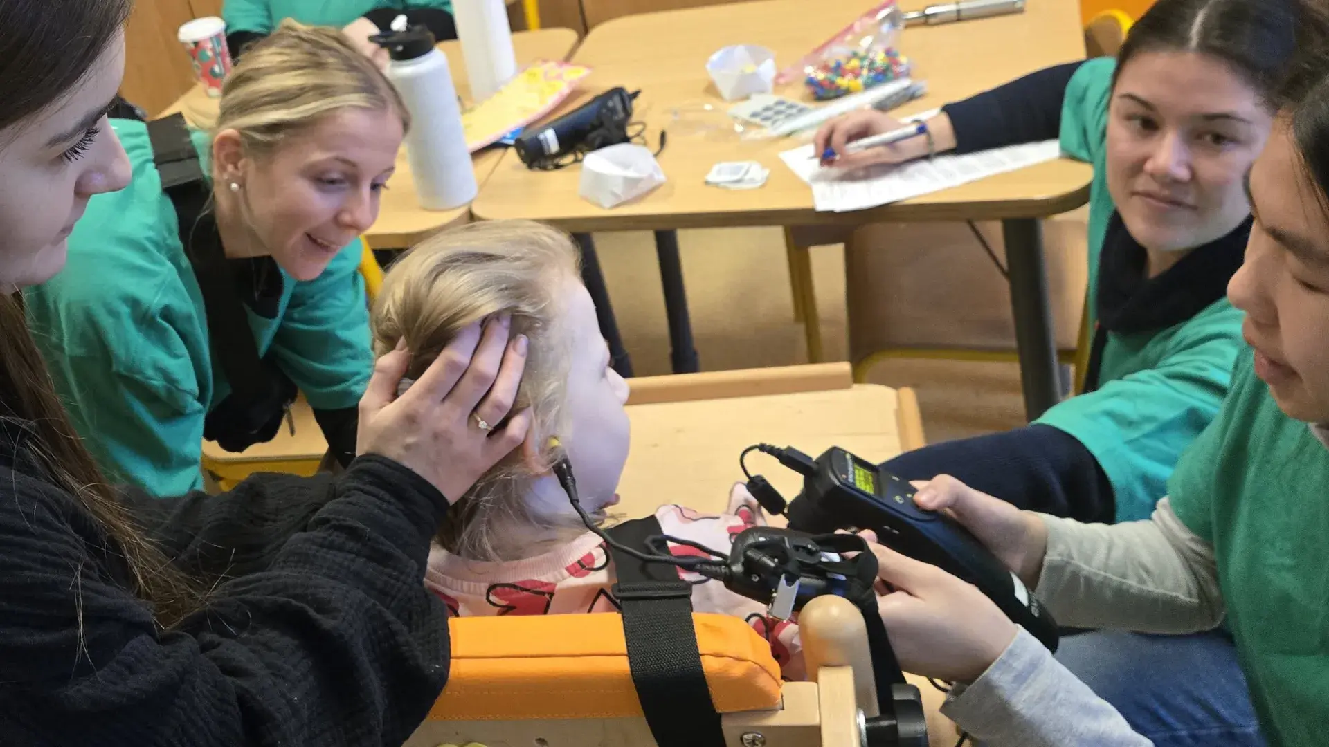three IHP students and Polish school principal with student  