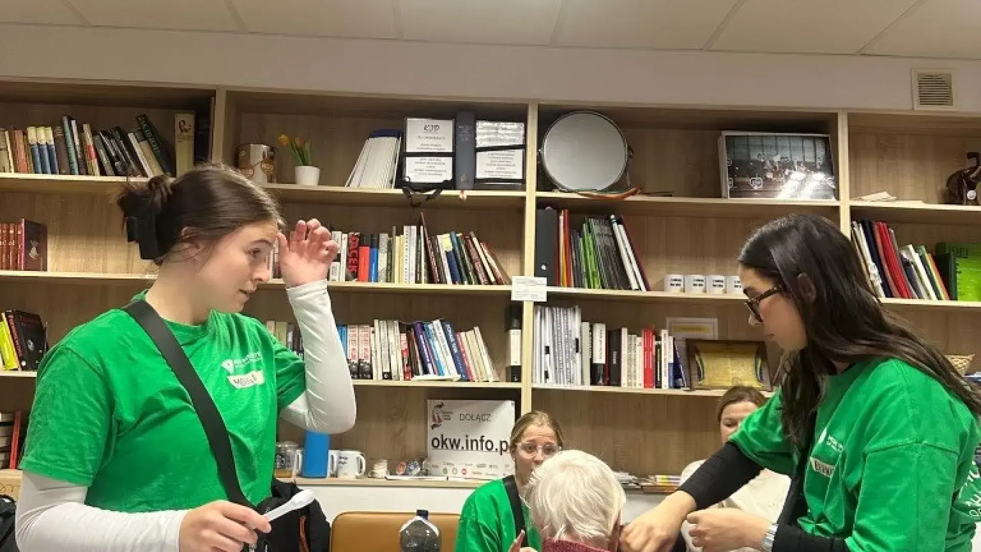 Two students with patient, preparing earmold 