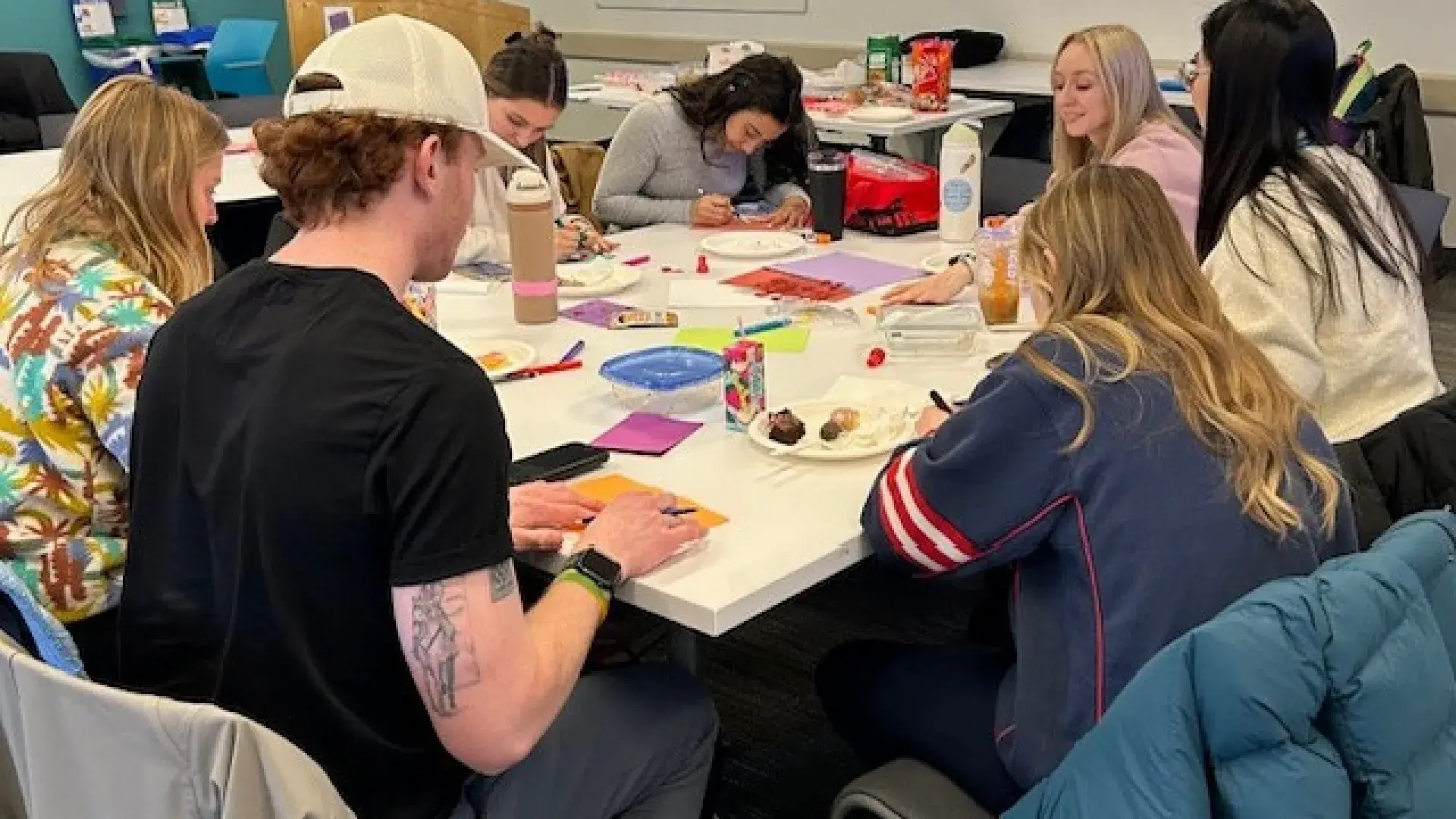 Group of adults around a table making cards