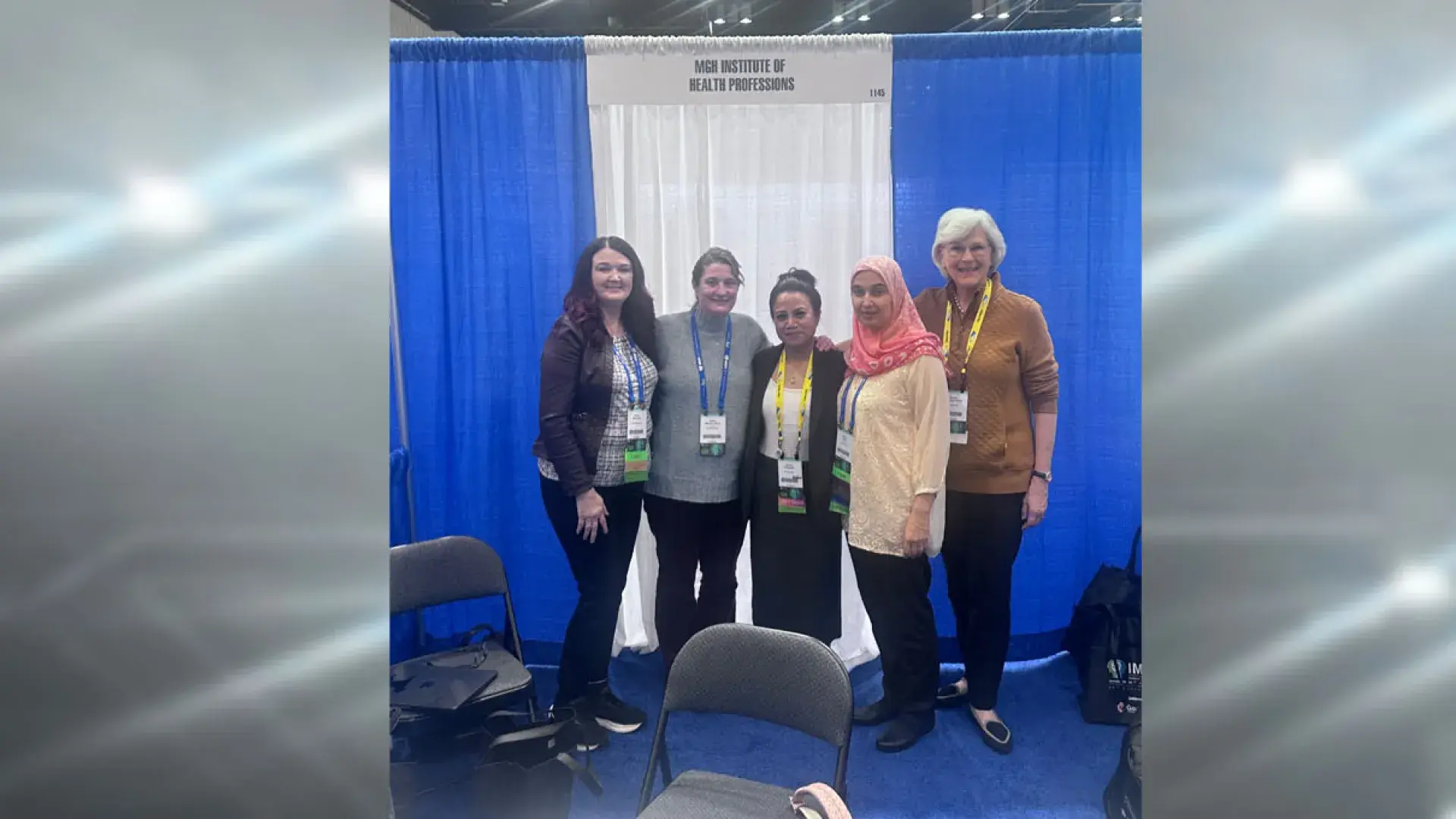 Five women standing in front of a blue and white curtain