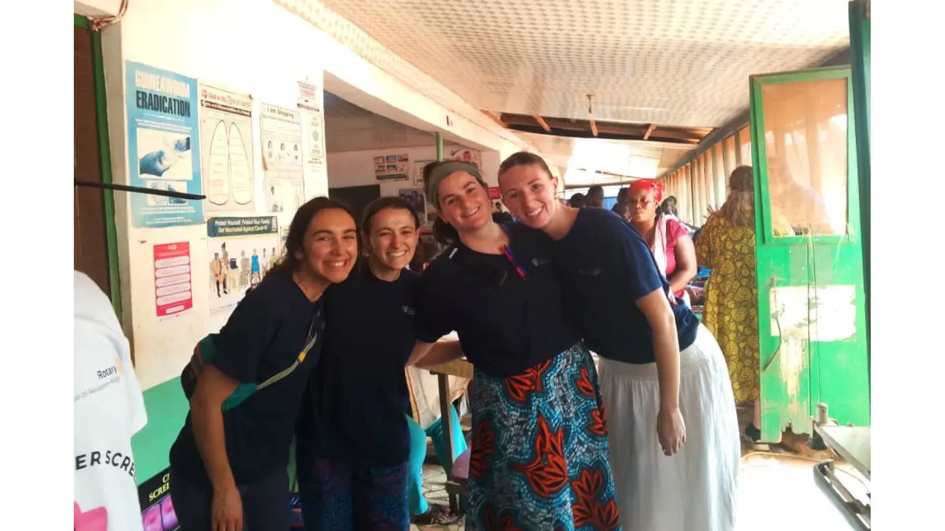 Four women standing next to each other pose for the camera