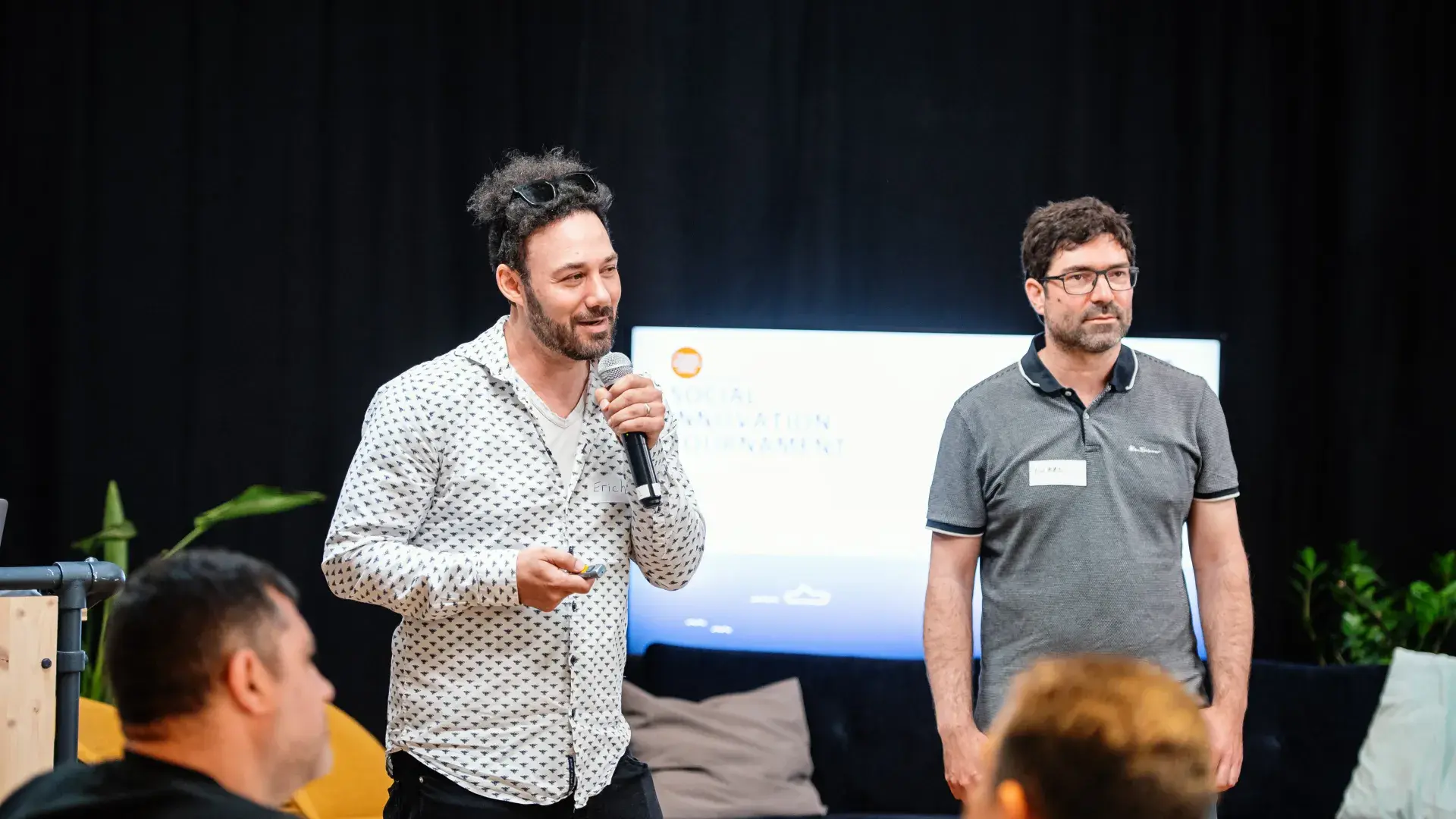 two men talking to audience 