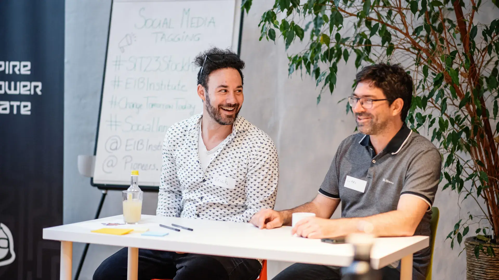 two men sitting at table 
