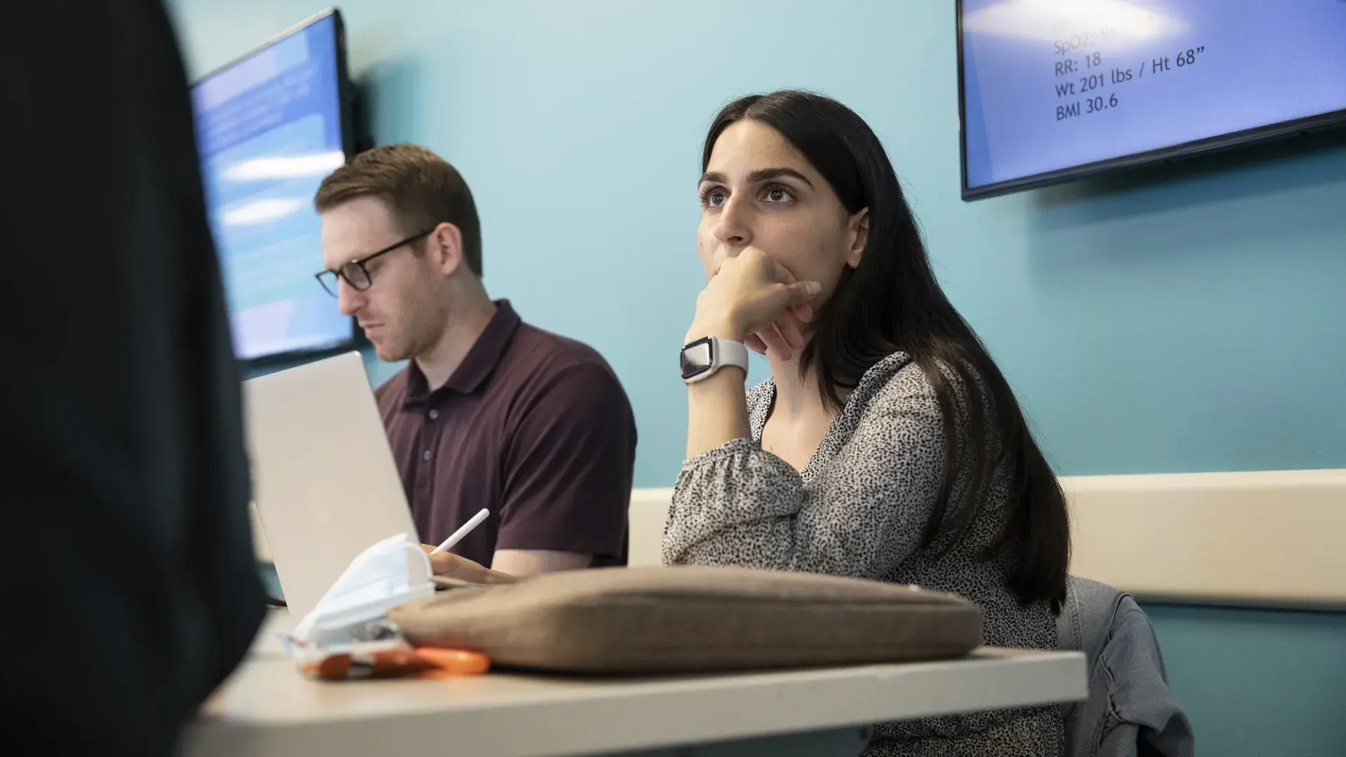 a student listens to a teacher