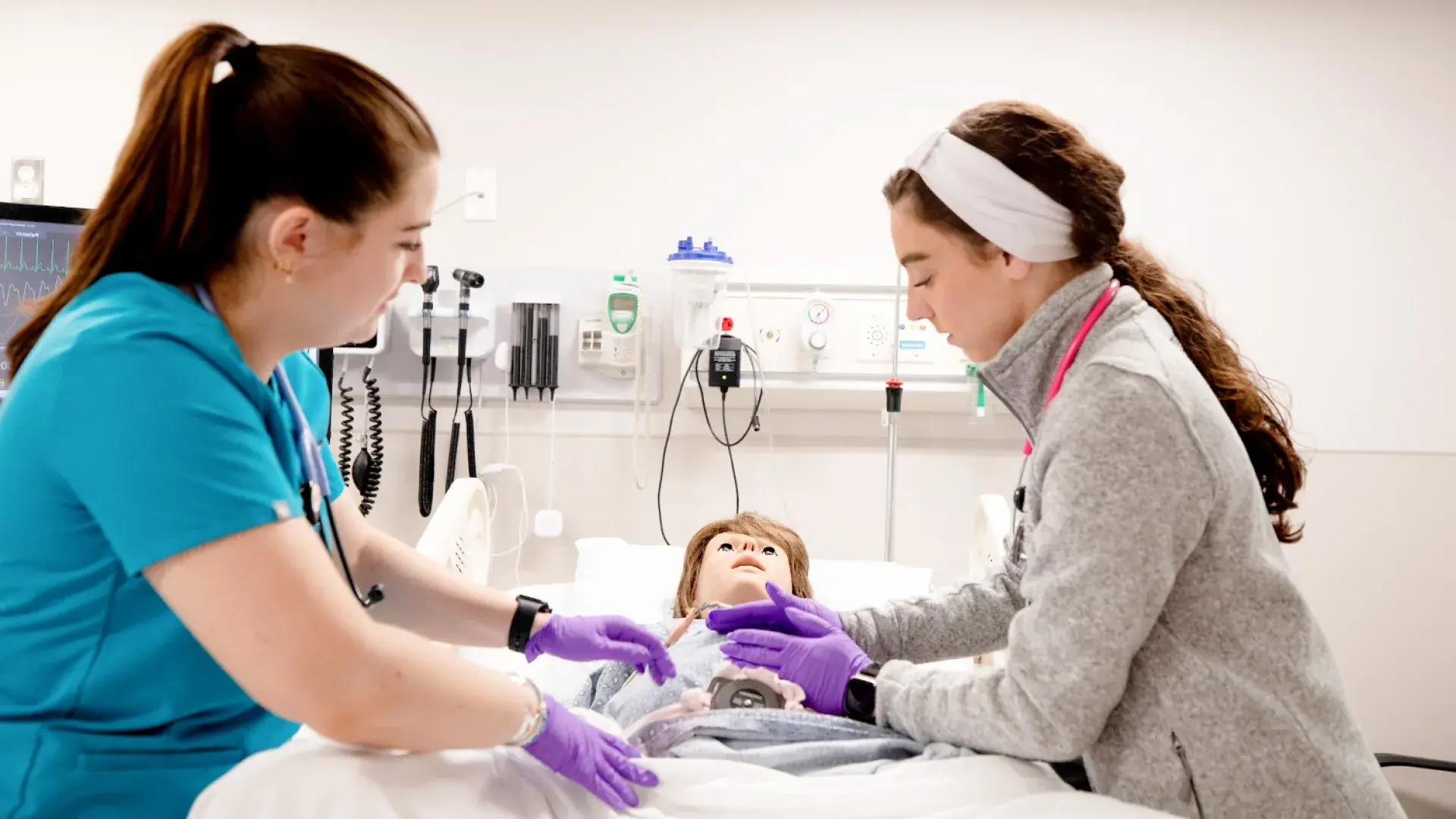 Two nursing students with mannequin baby 