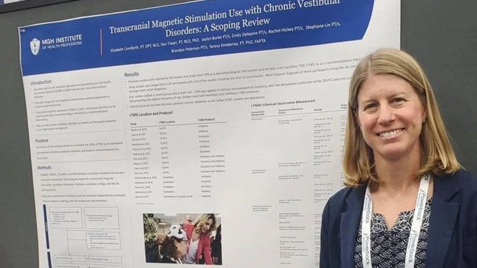 A woman stands in front of a research poster