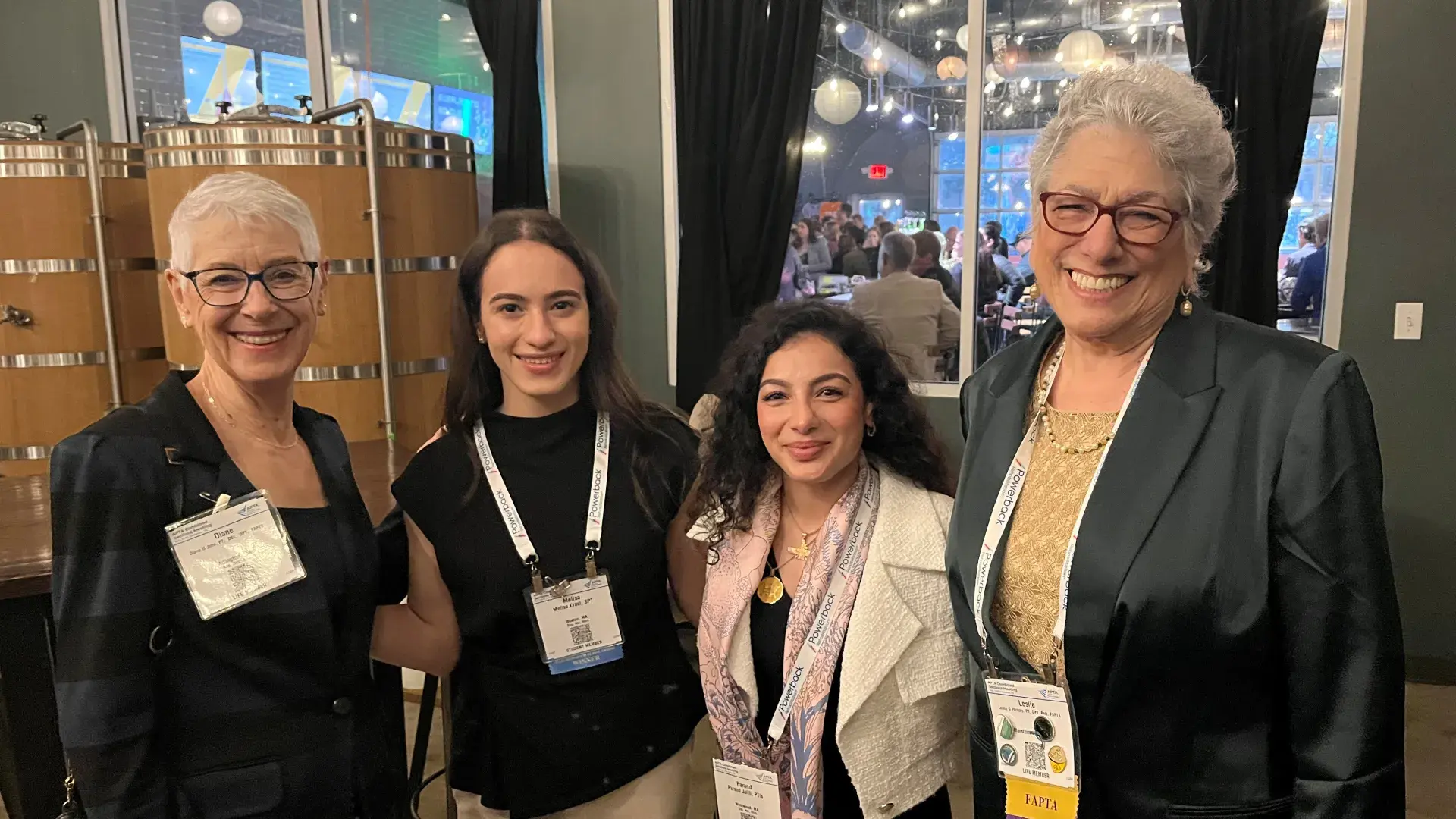 Four women pose at an event