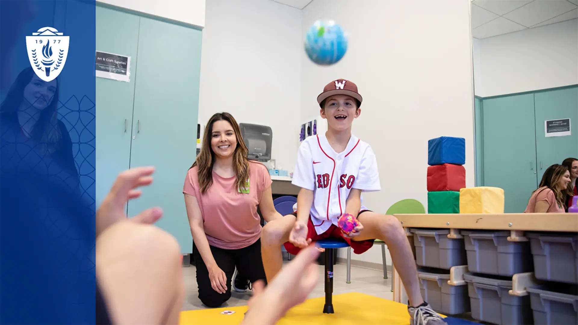 a boy throws a ball showing what occupational therapists do in a therapy setting