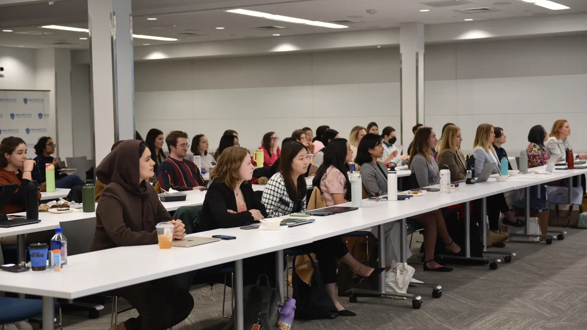 Several people sitting around a white table