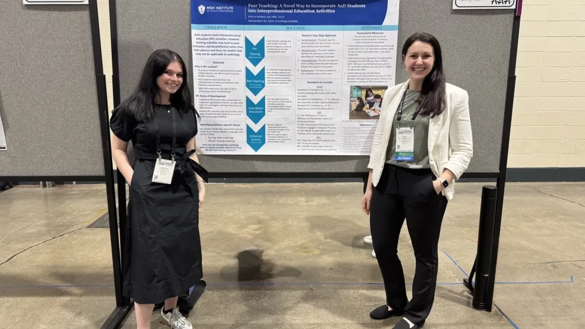 Two women in front of a poster