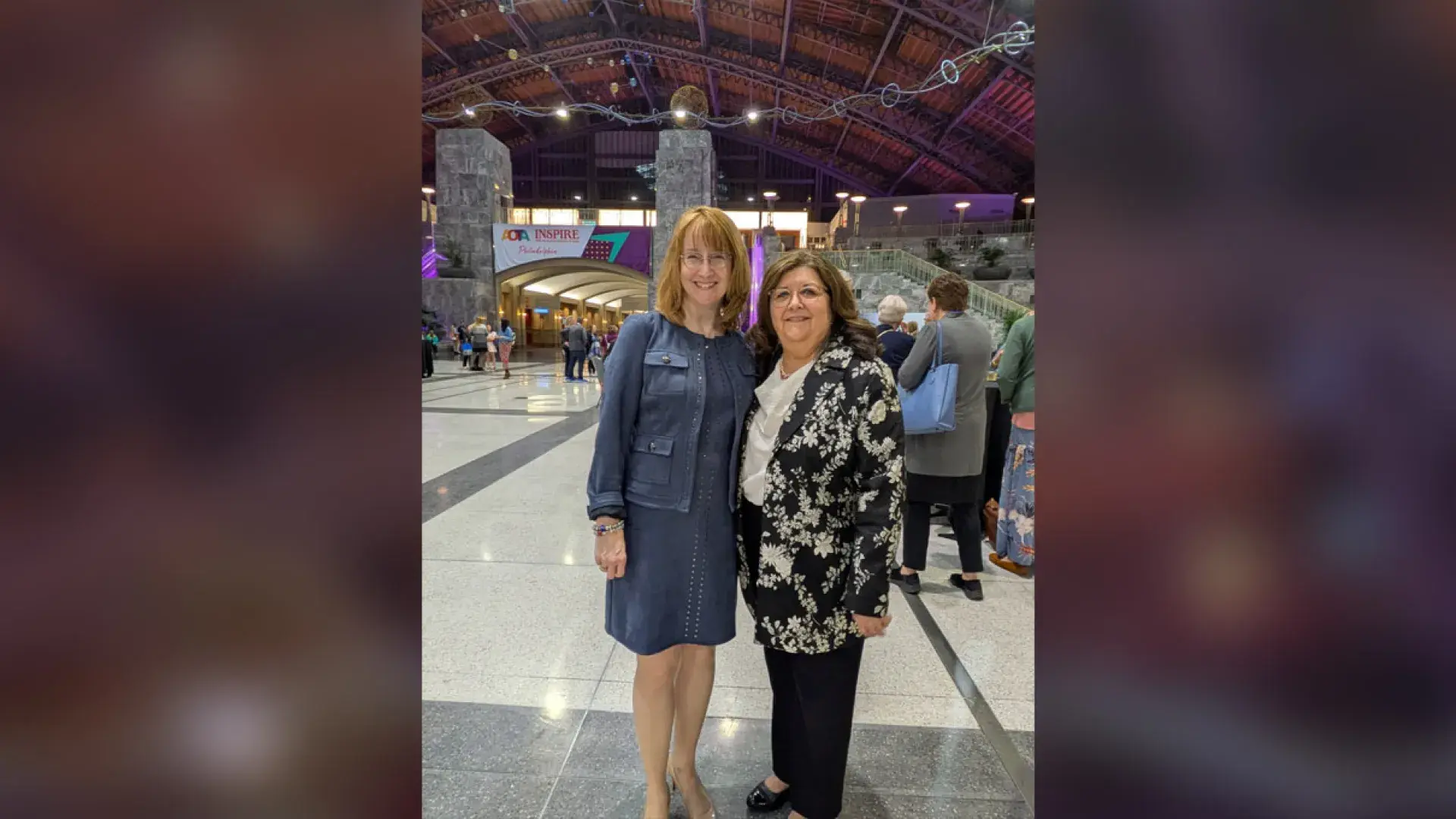 Two women pose for the camera