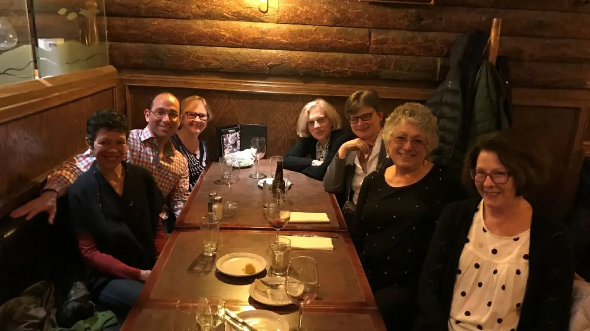 Seven people sit around a table