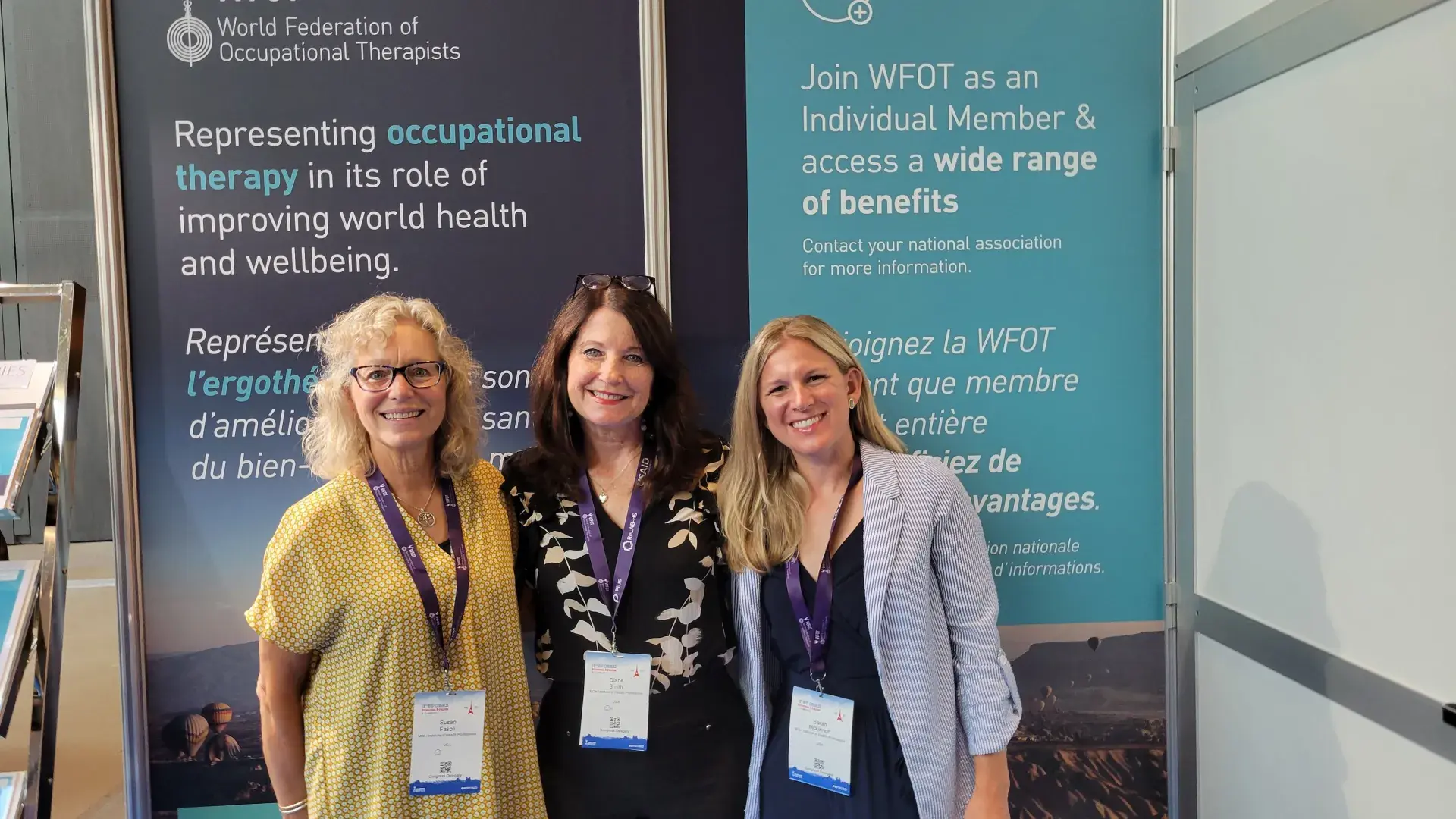 photo of three women in front of a banner