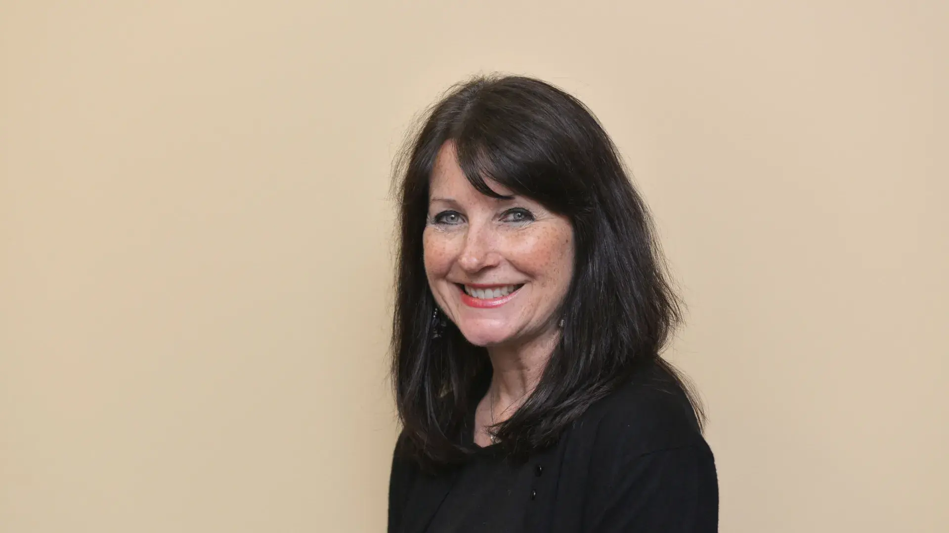 A photo of a woman smiling.