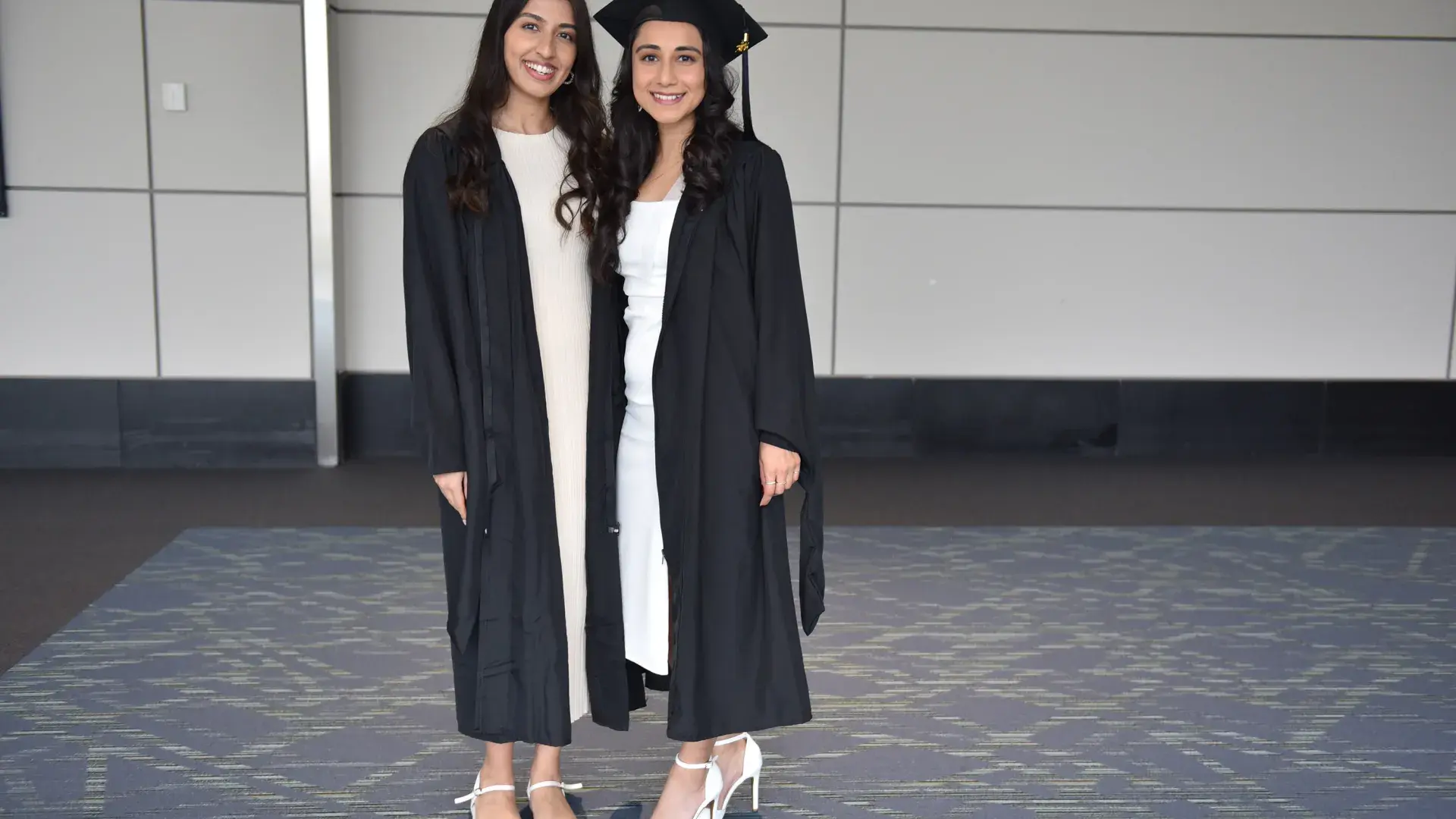 Two women in cap and gowns