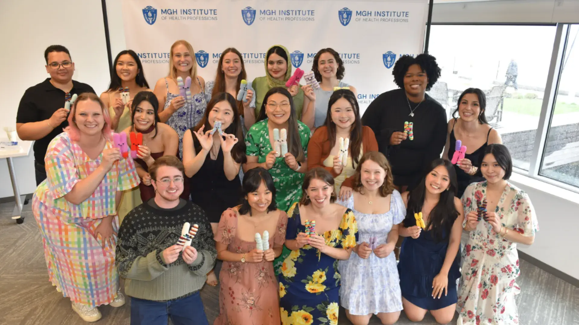 Large group of people holding knit items
