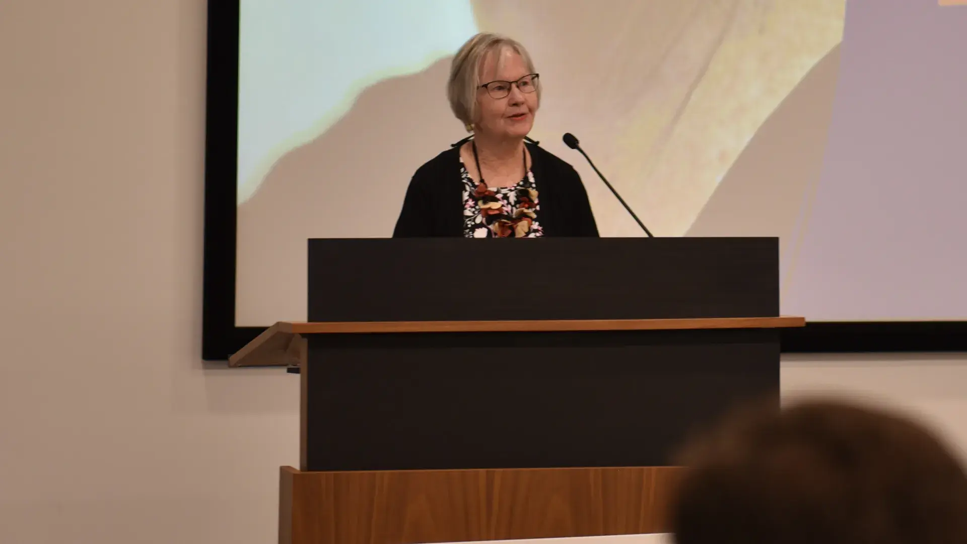 A photo of a woman at a podium