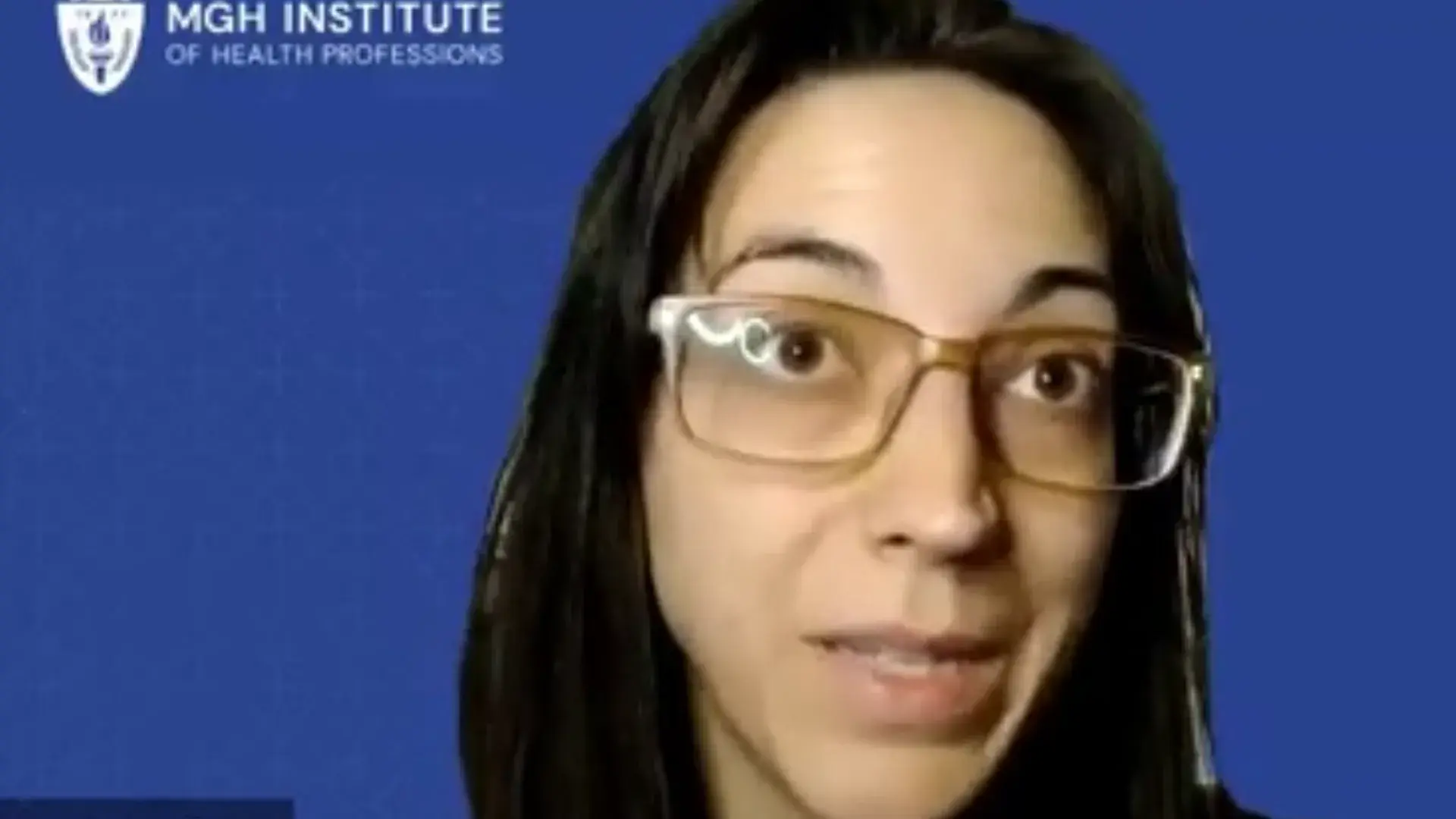 screengrab of a woman with a blue background