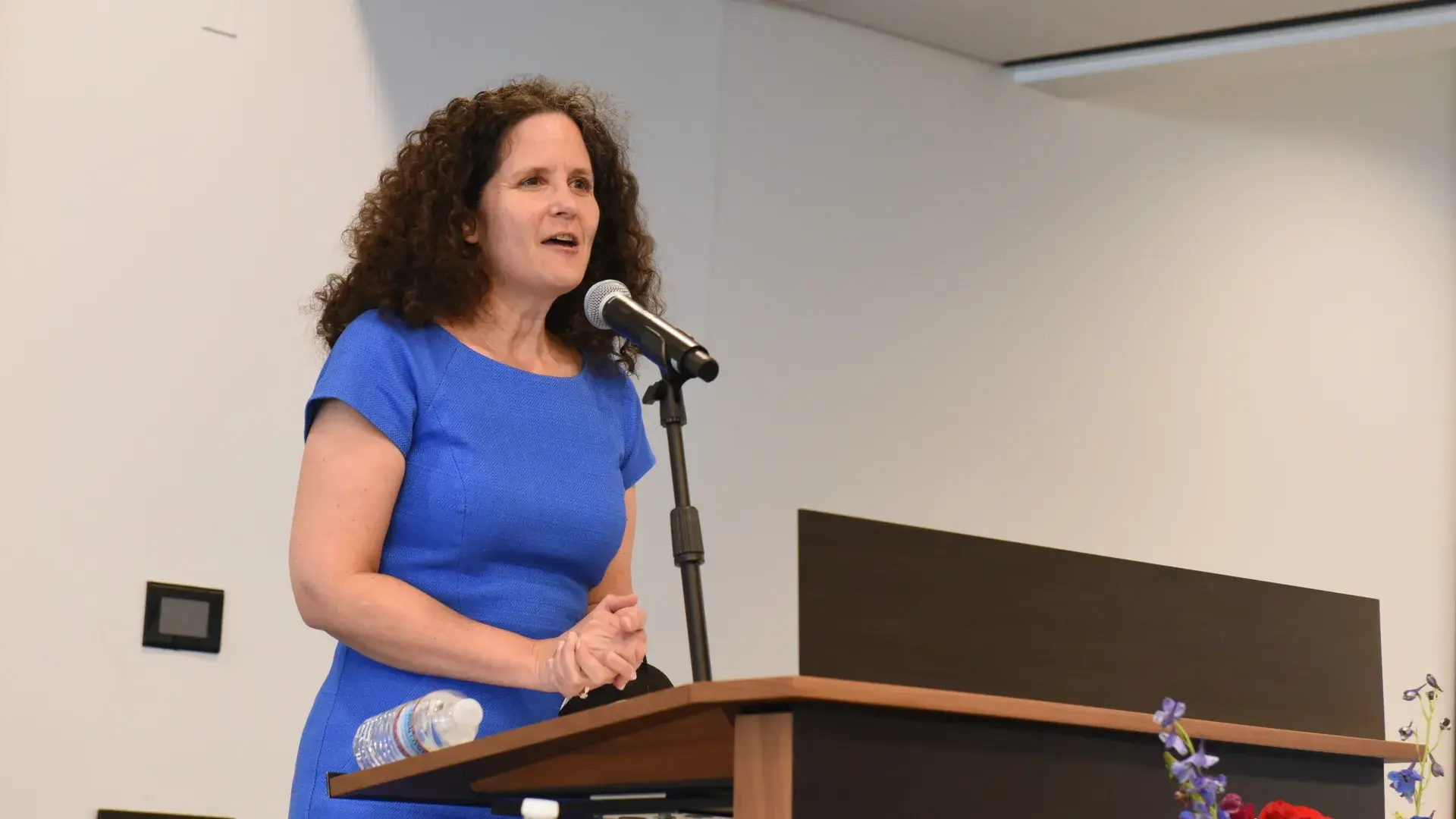 A woman speaks at a podium