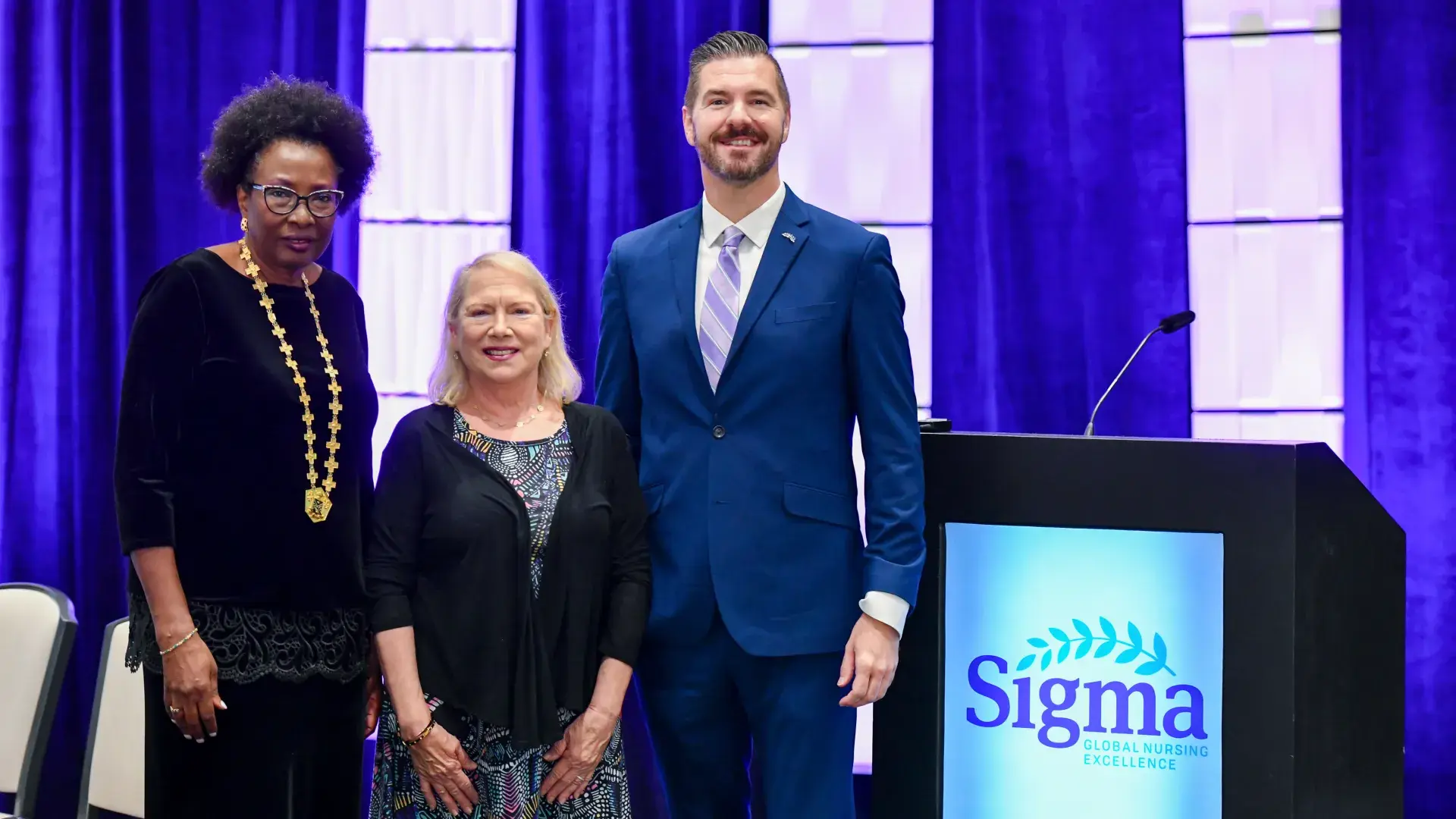 Nicholas posing with woman and man 