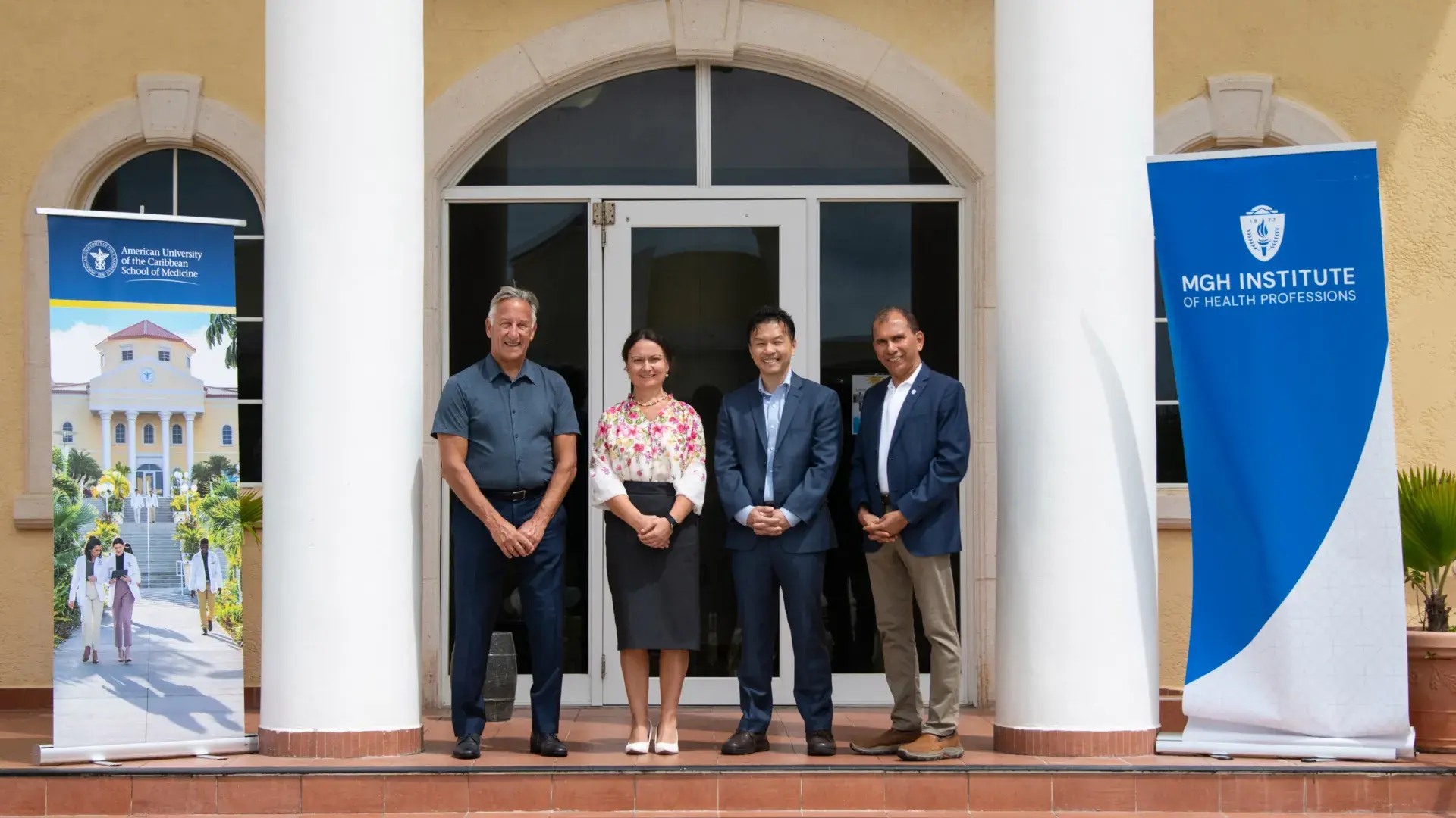4 people standing on a porch between two columns