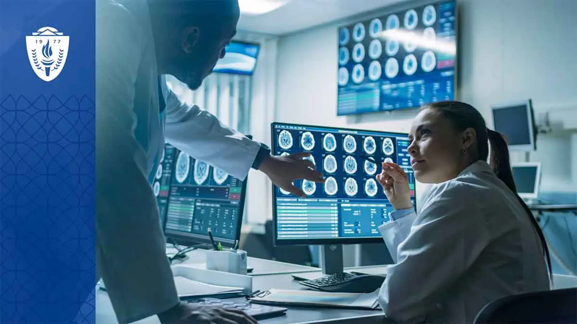 Two scientists in white lab coats looking at medical images on a computer monitor