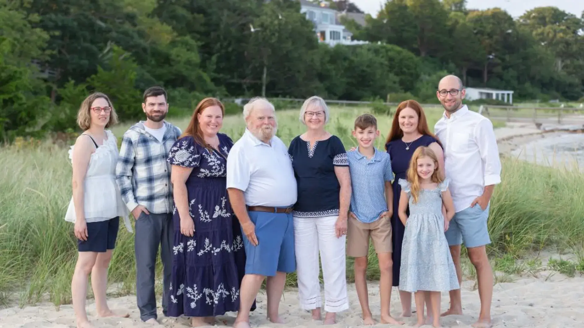 A group of people pose on a beach