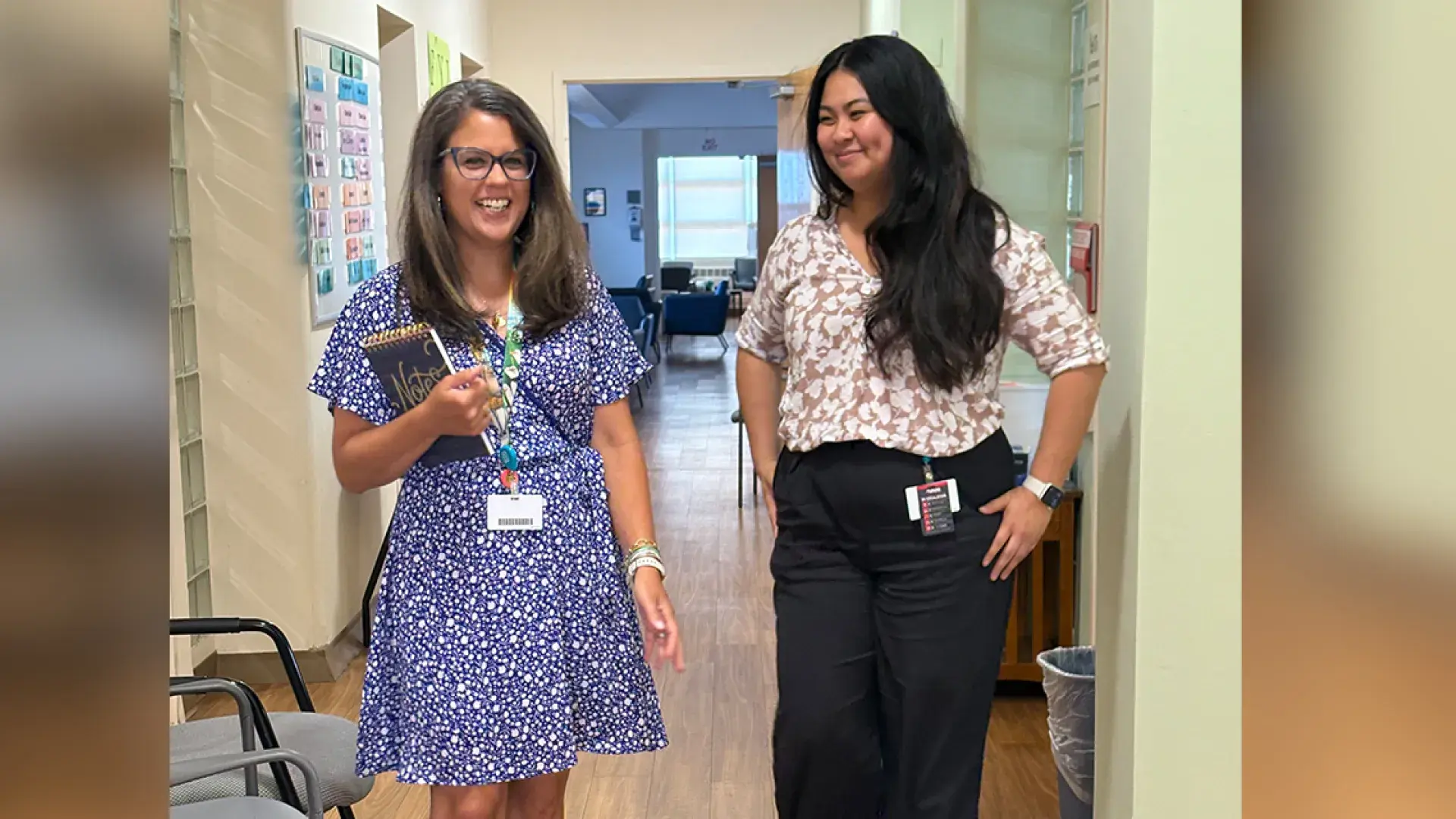 two women walking in hallway 