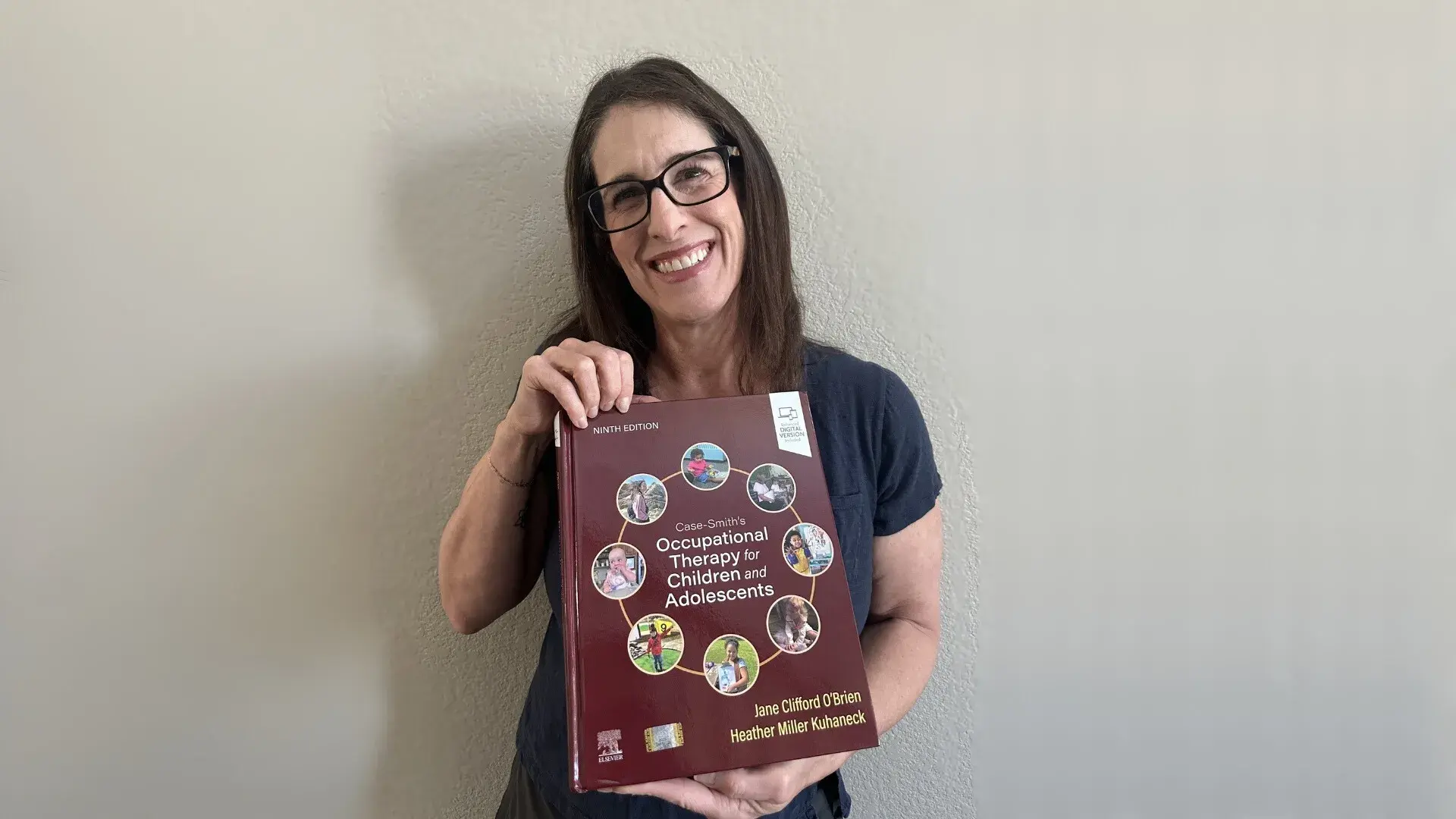 A photo of a woman holding a book