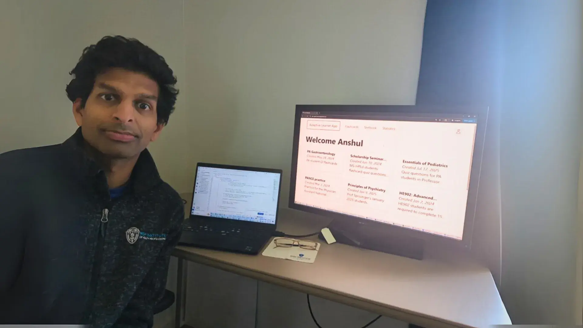 a photo of a man in front of a computer