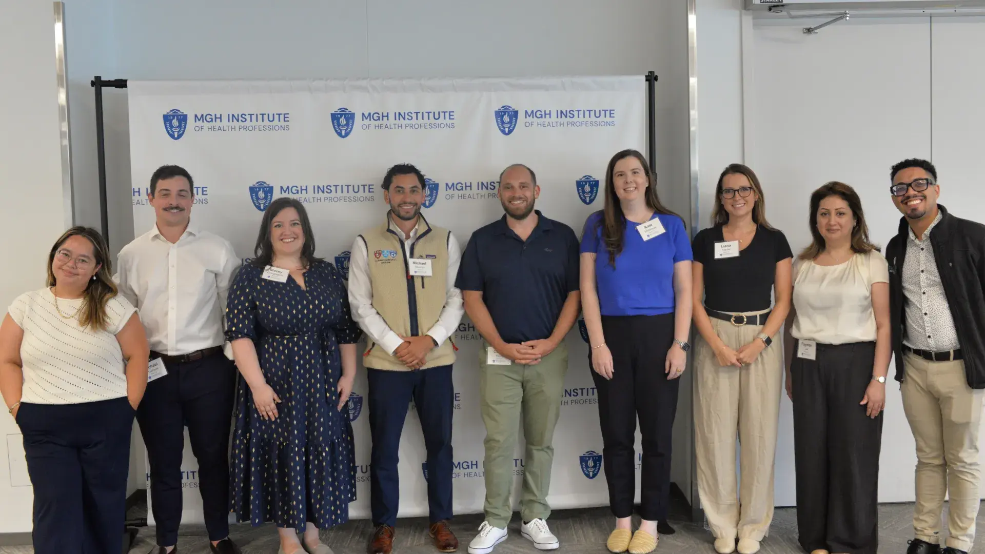 9 people in front of a background that says MGH Institute