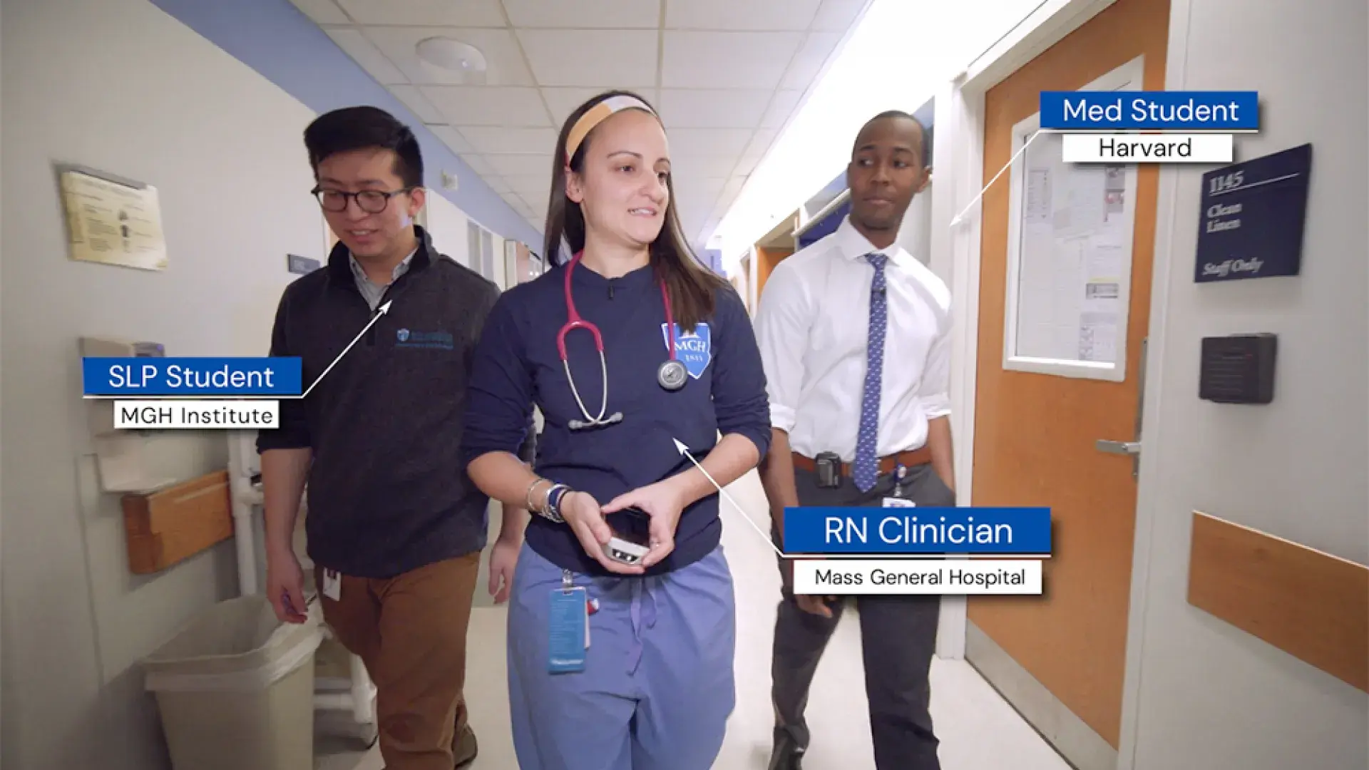 three students walk down a hospital hallway