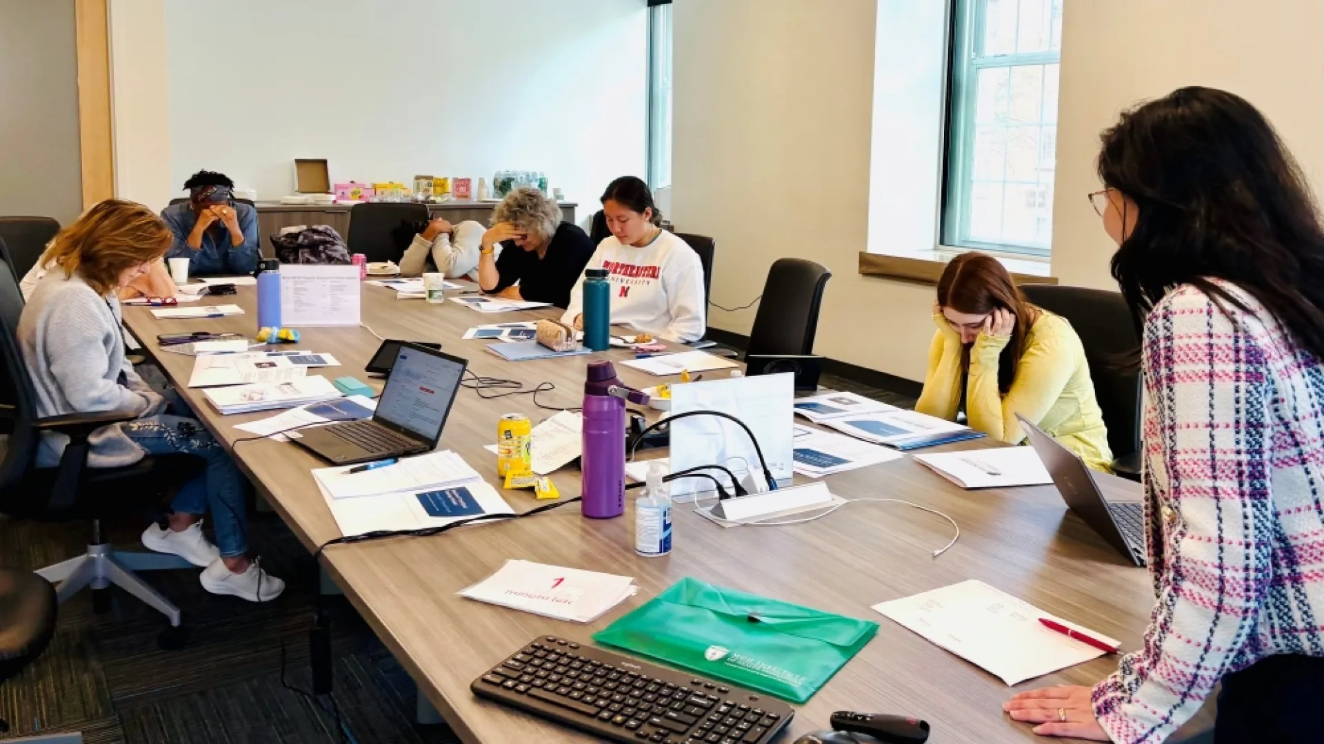 People sit around a table with one person at the head