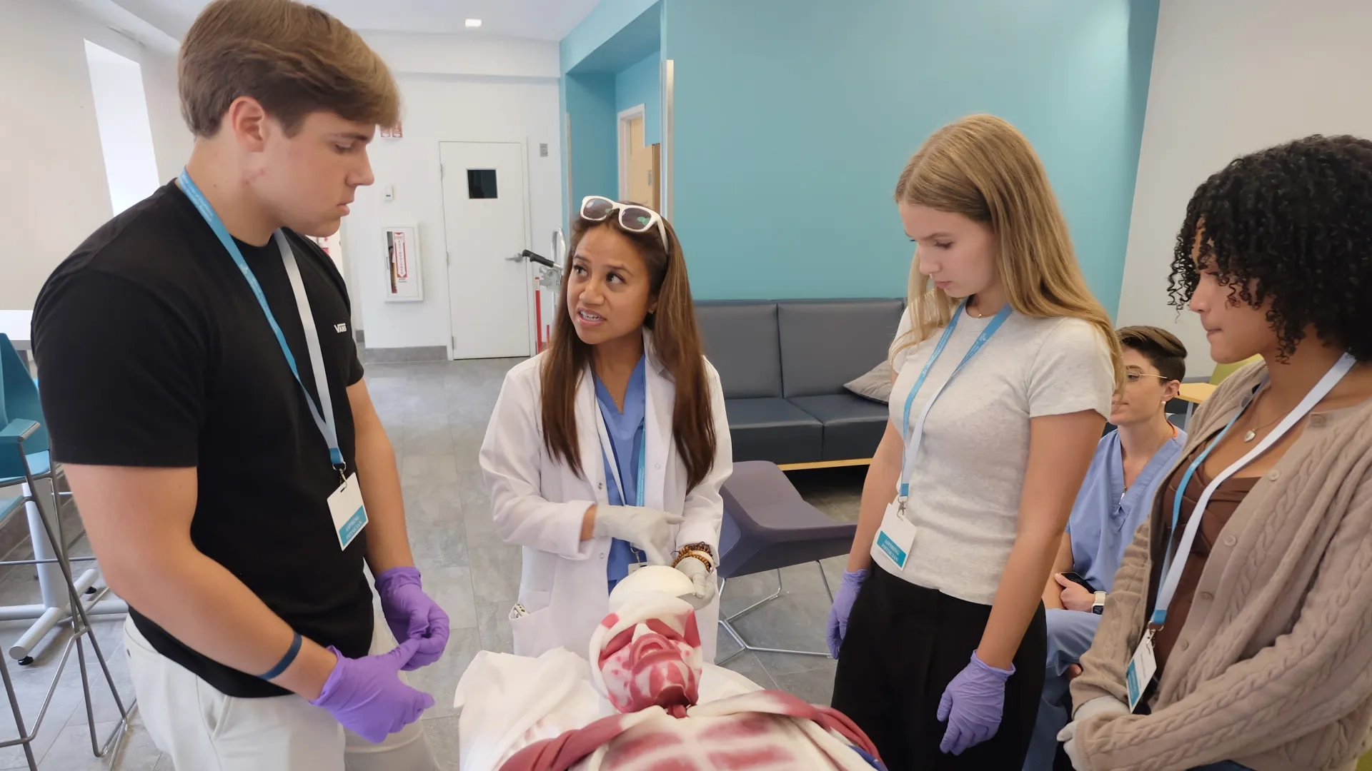 young adults stand around a plastic replica of the inside of a body
