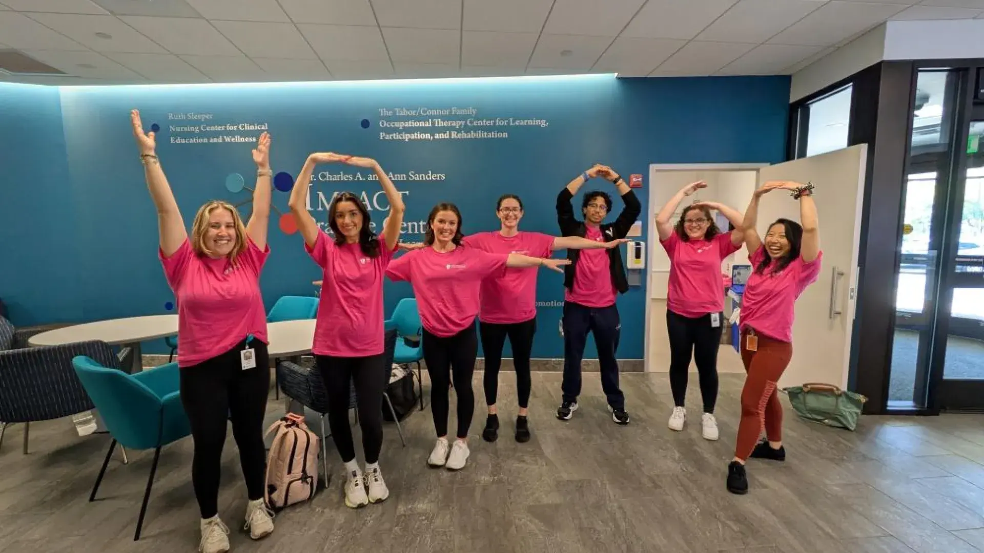People stand in various states of movement in an open area 