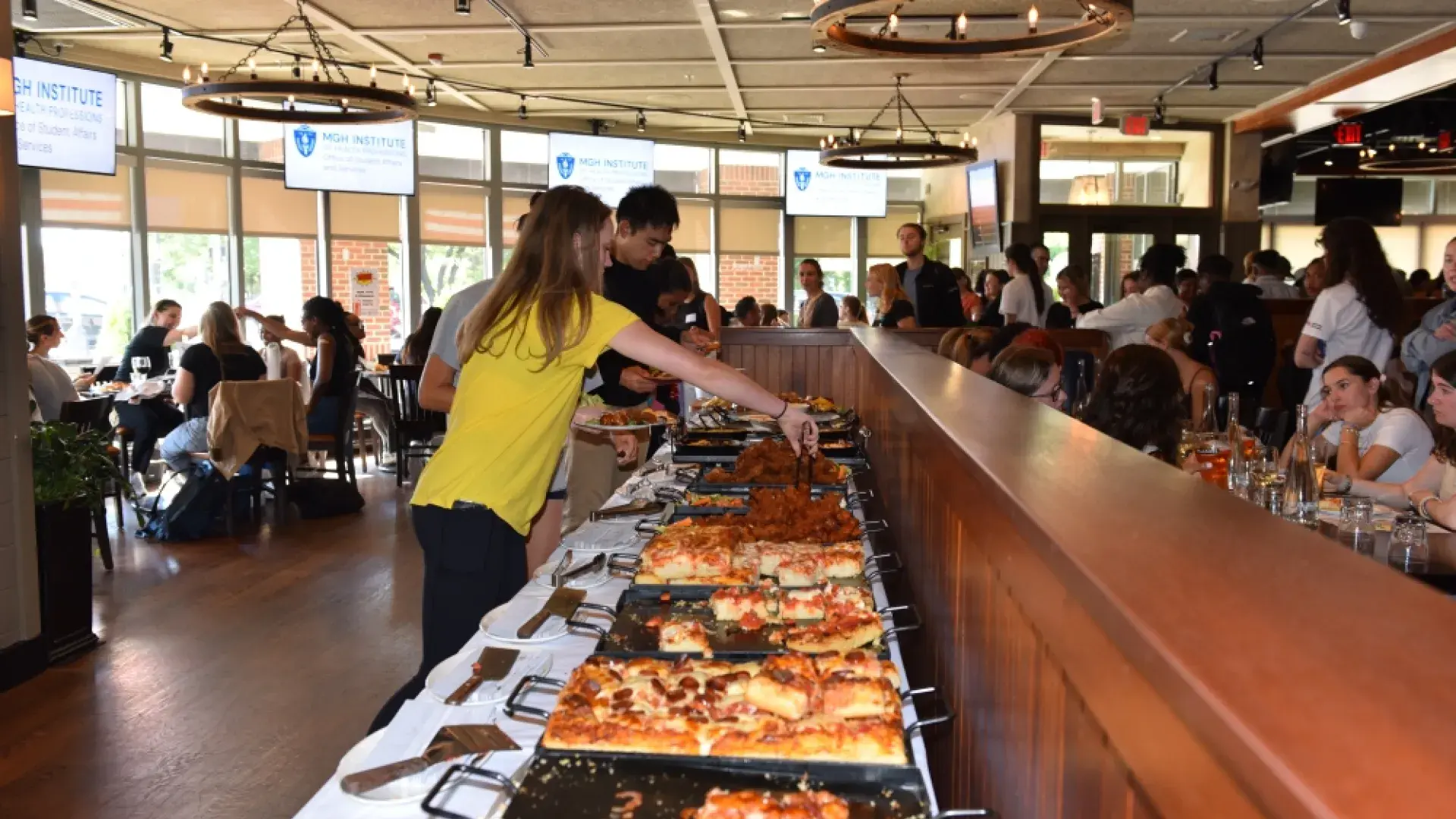 People serve themselves at a buffet