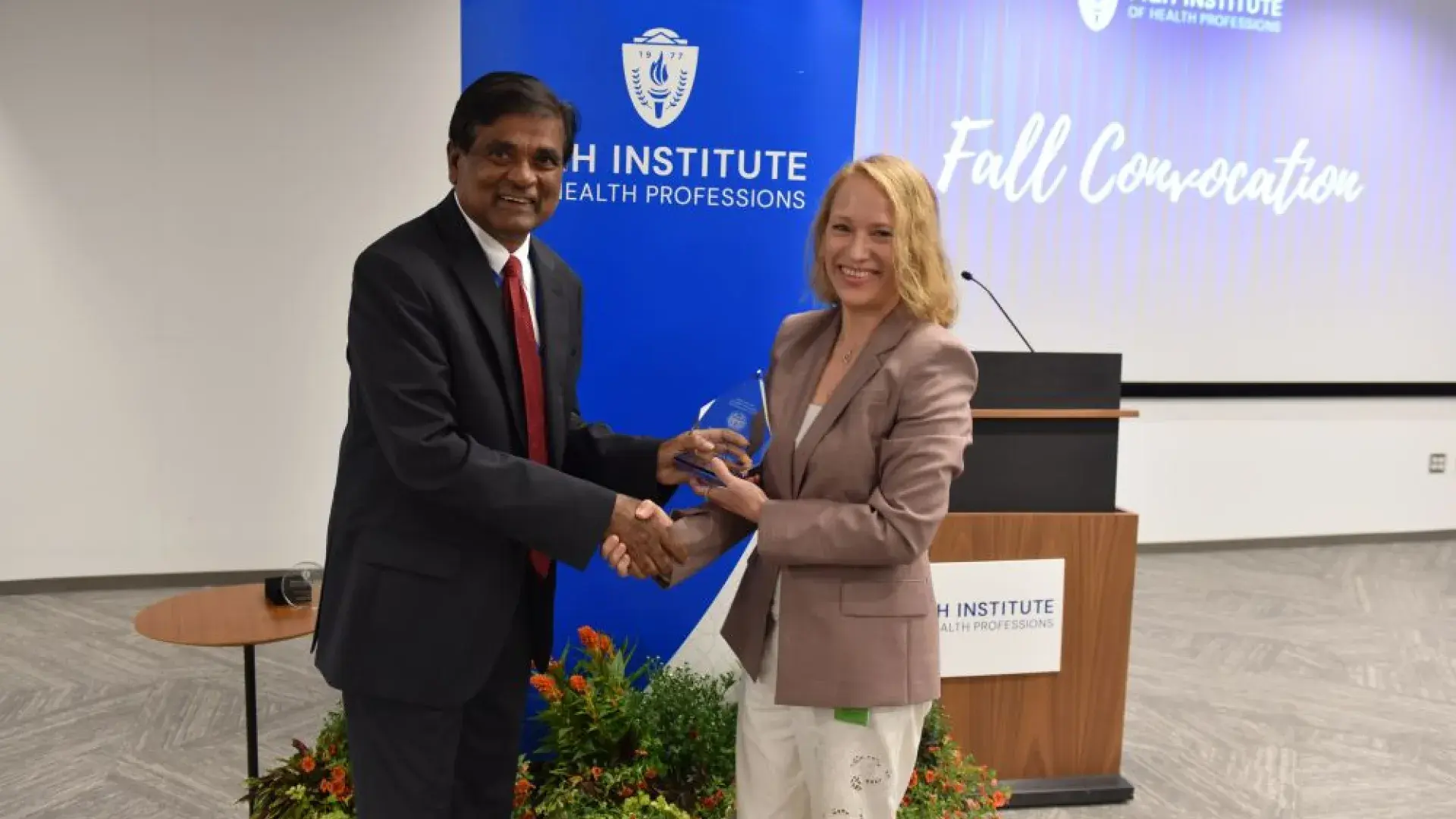Man and woman holding award