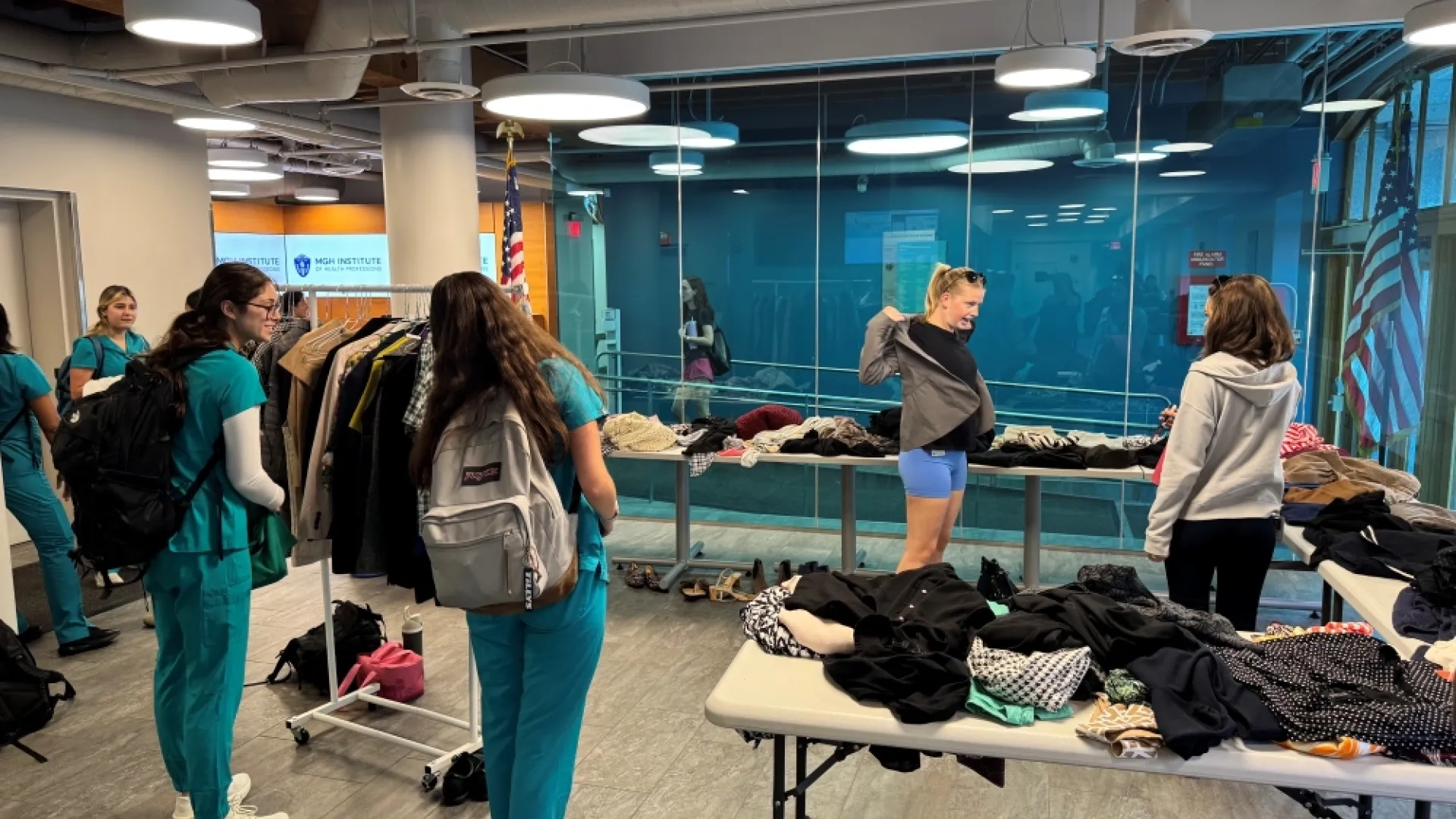 4 women around piles of clothes