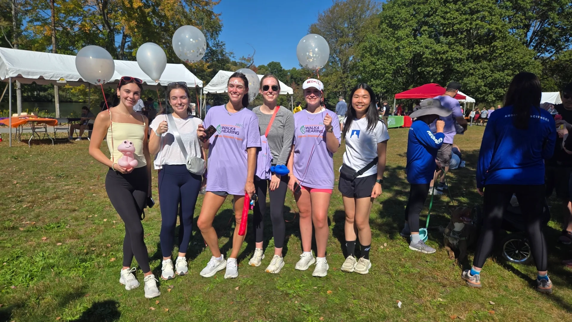5 women posing with balloons