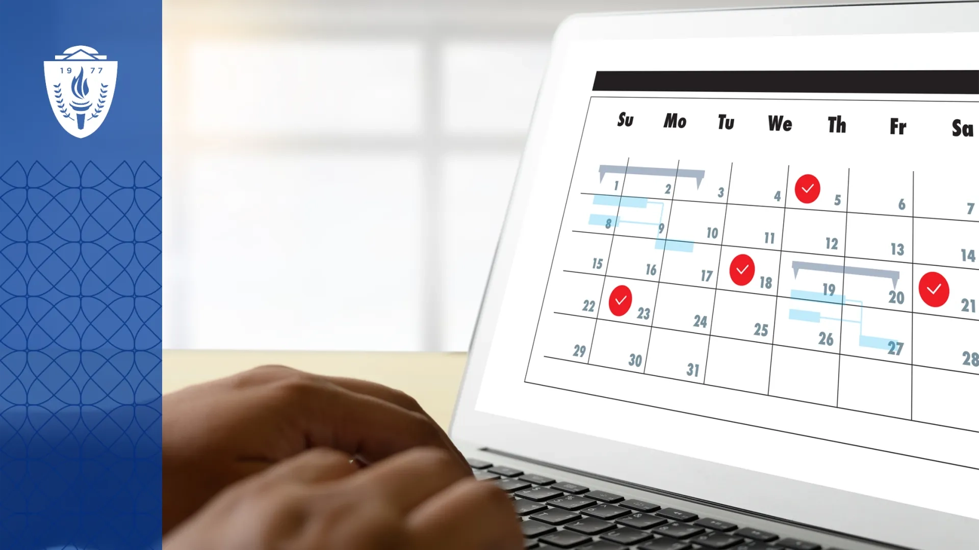 Laptop with a full screen calendar displayed. A person's hands are typing on the keys.