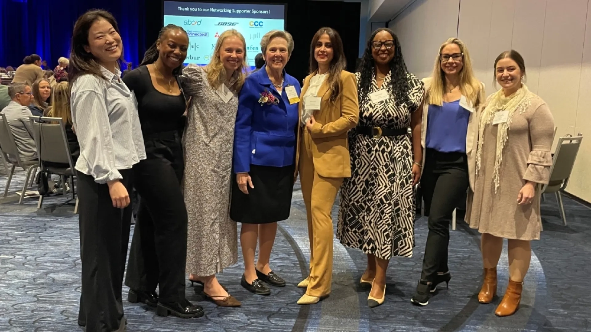 Eight women pose for a photo
