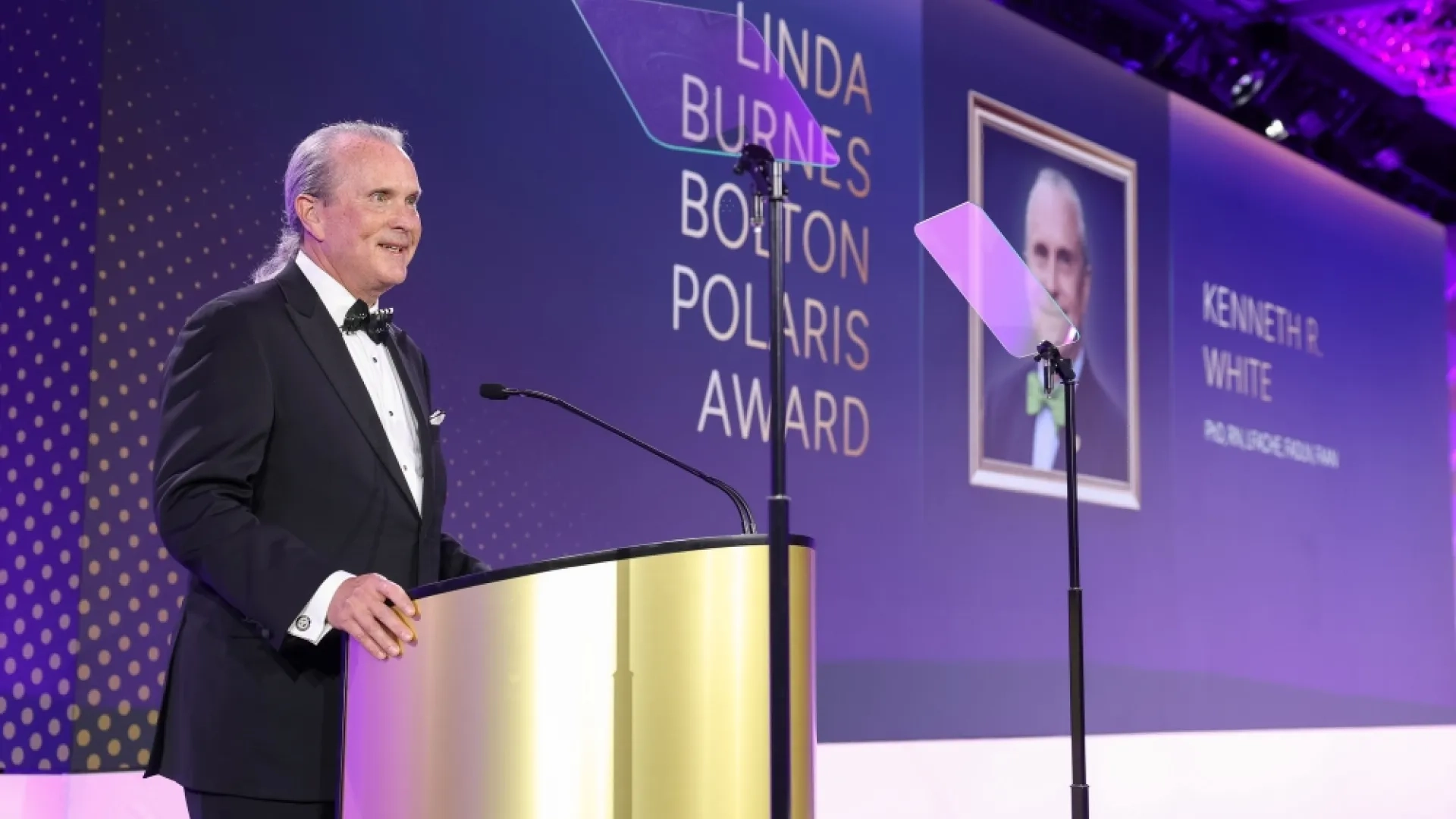 A man stands at a podium