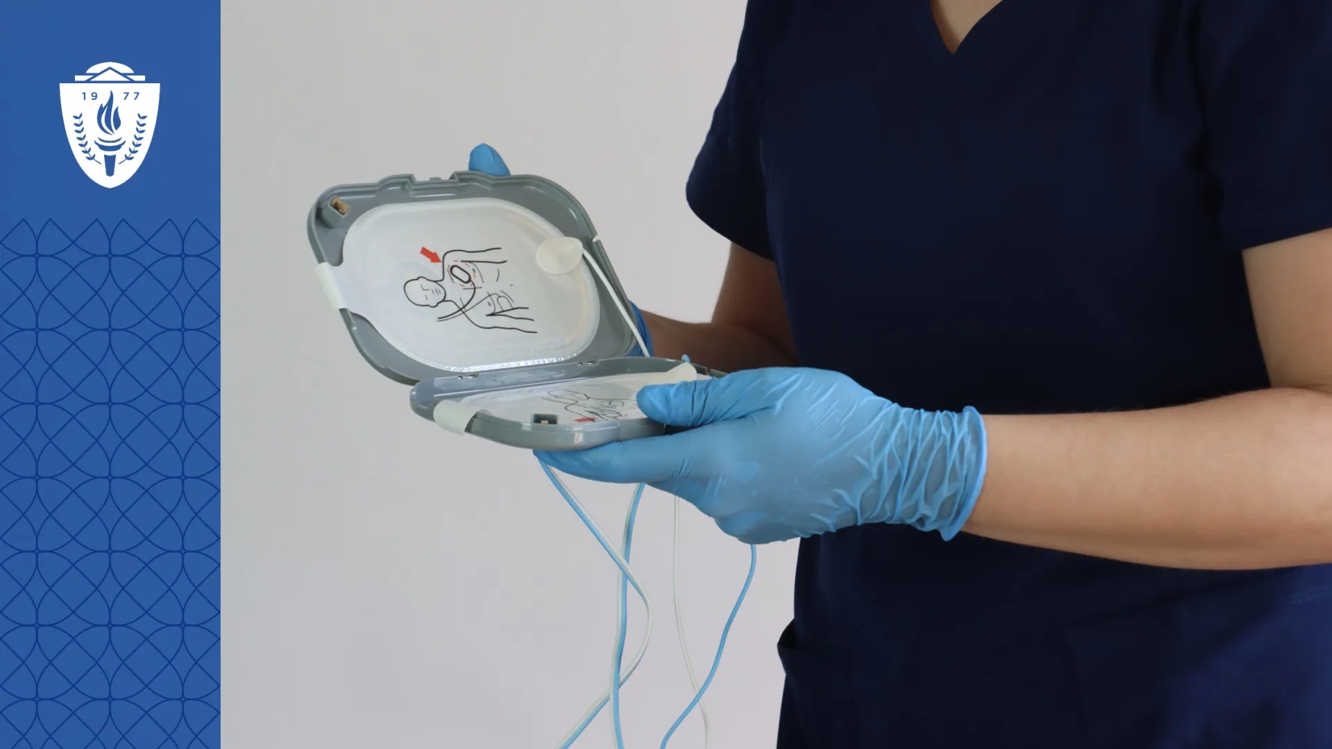 Cardiac technicial holding medical device and wearing blue medical glues
